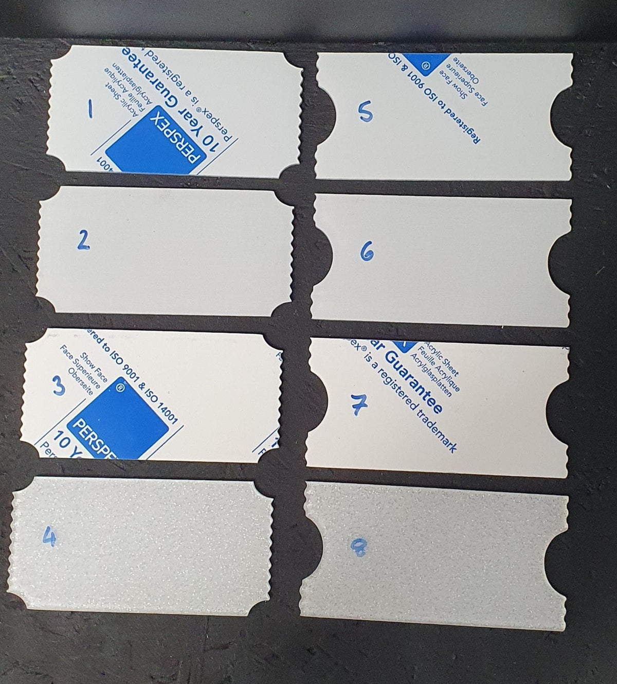 Premium 3mm cast acrylic ticket blanks in two decorative ticket styles, shown in clear, white, sparkling and clear with white reverse sublimation finish options.