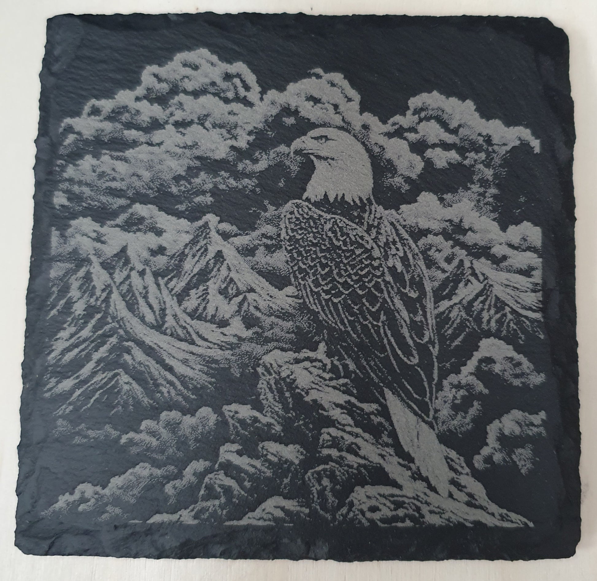 Slate coaster with engraved design of an eagle and mountain landscape