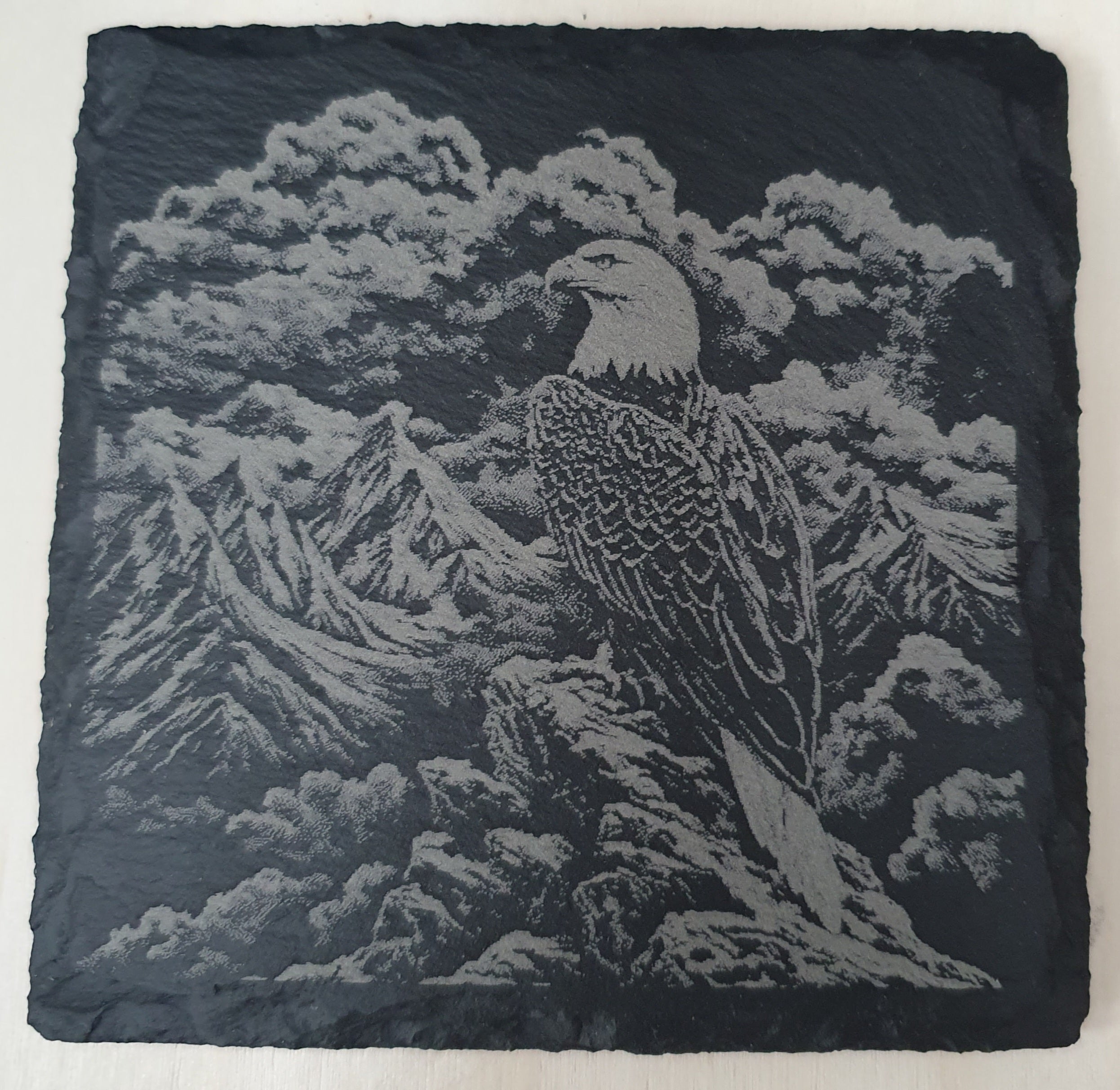 Slate coaster with engraved design of an eagle and mountain landscape