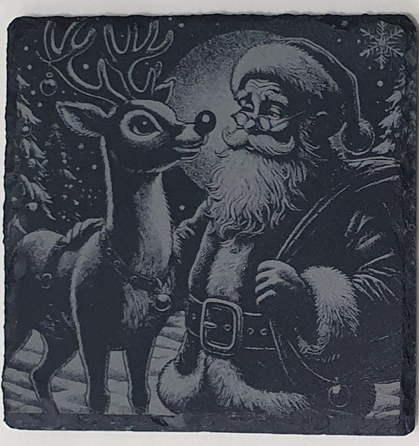 Decorative stone with a black and white illustration of Santa Claus and a reindeer in a snowy scene.