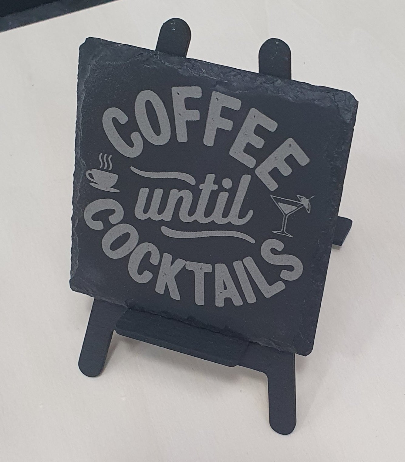 Slate sign with 'Coffee until Cocktails' text on a stand
