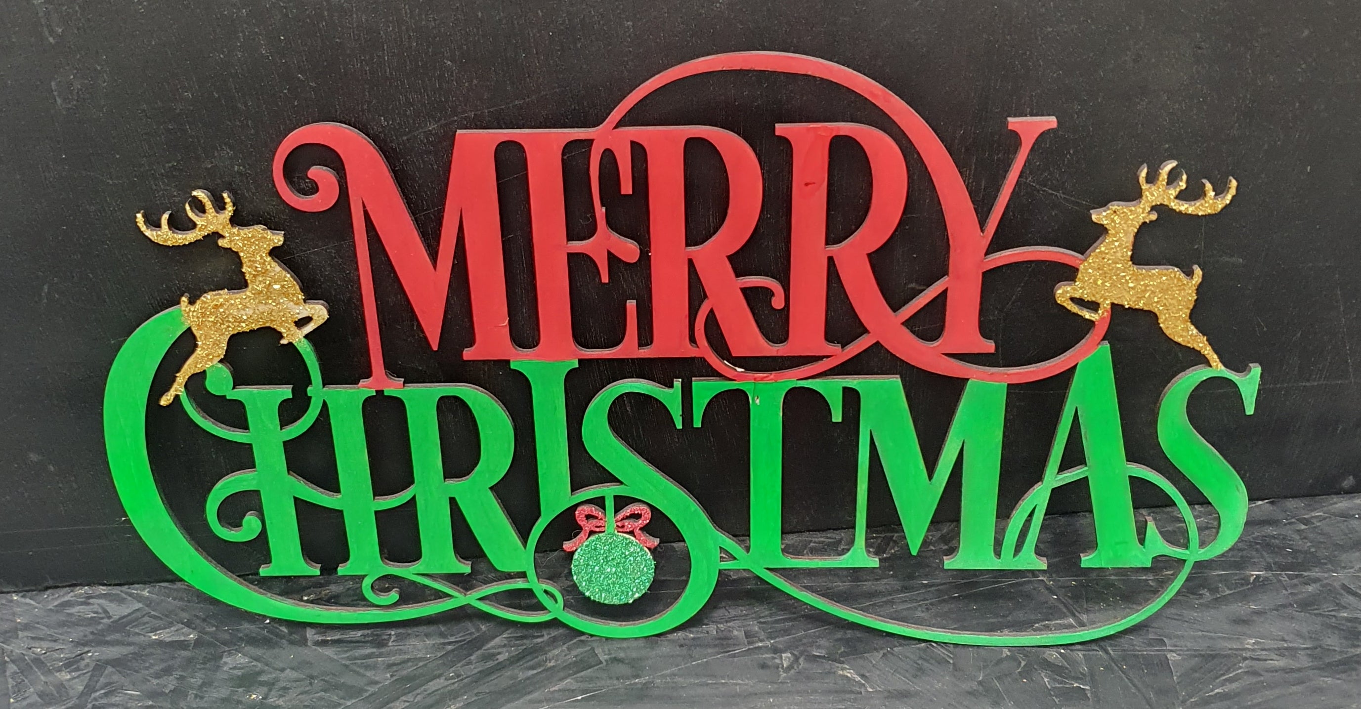 Decorative sign with 'Merry Christmas' text and reindeer.