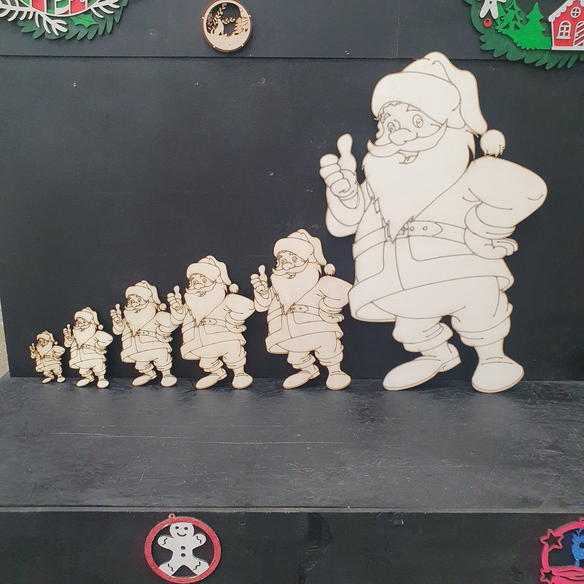 Wooden Santa Claus cut out figures ready to paint in various sizes.