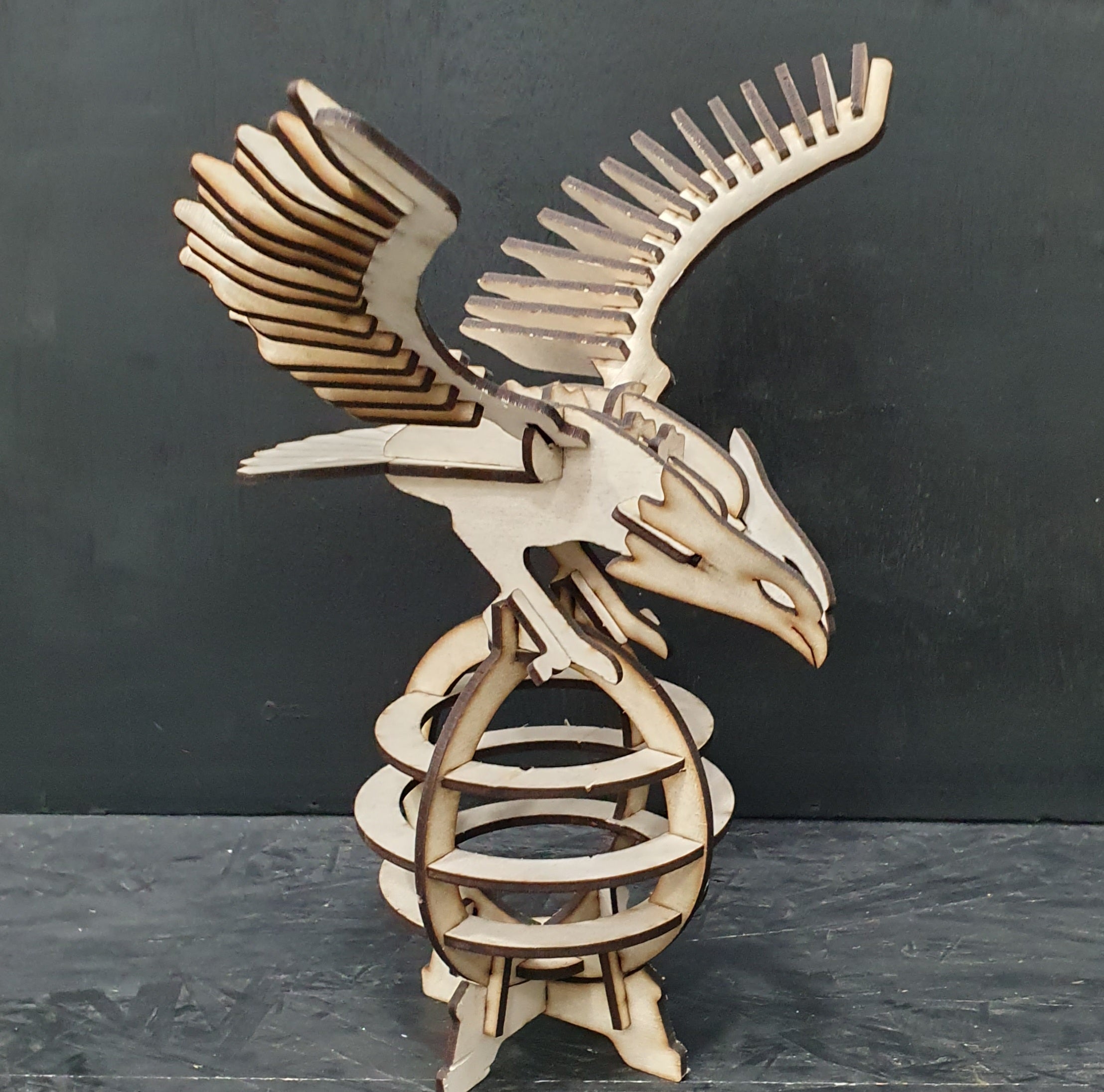Unassembled MDF eagle puzzle pieces from 3D construction kit