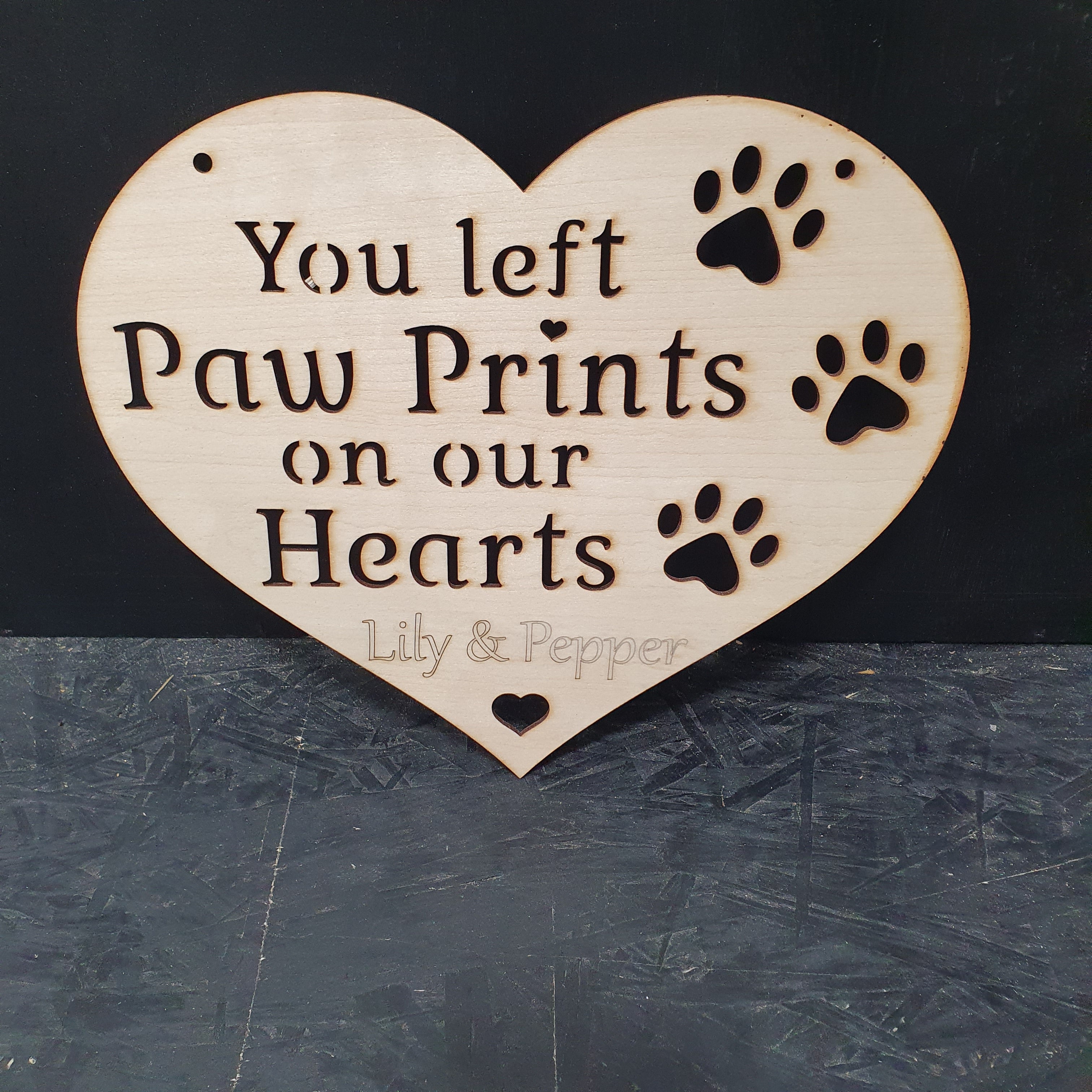 Honour the memory of a beloved pet with this beautifully crafted Paw Prints On Our Hearts Memorial Heart