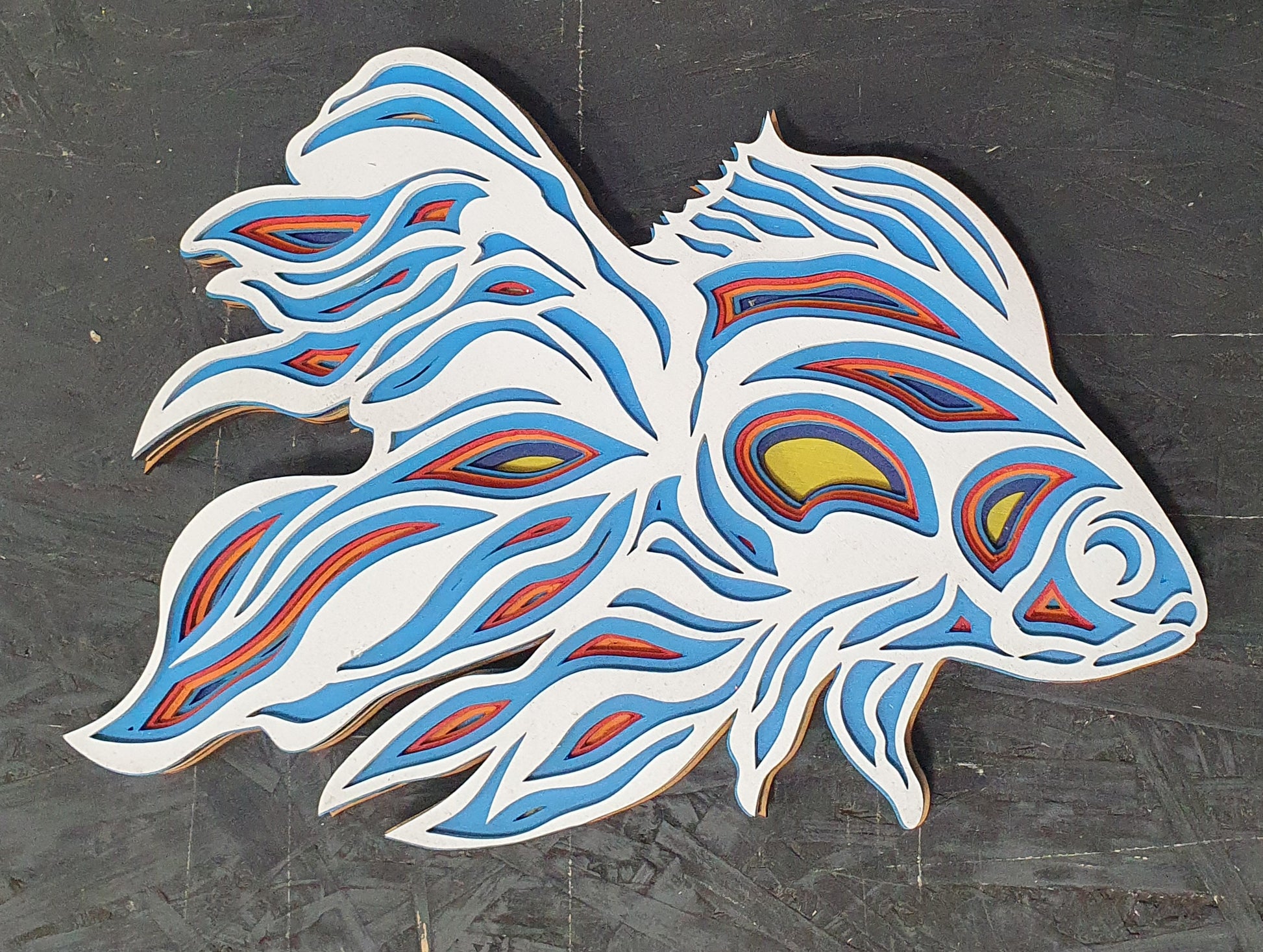 3D wooden fish artwork featuring multi-layer wavy pattern design