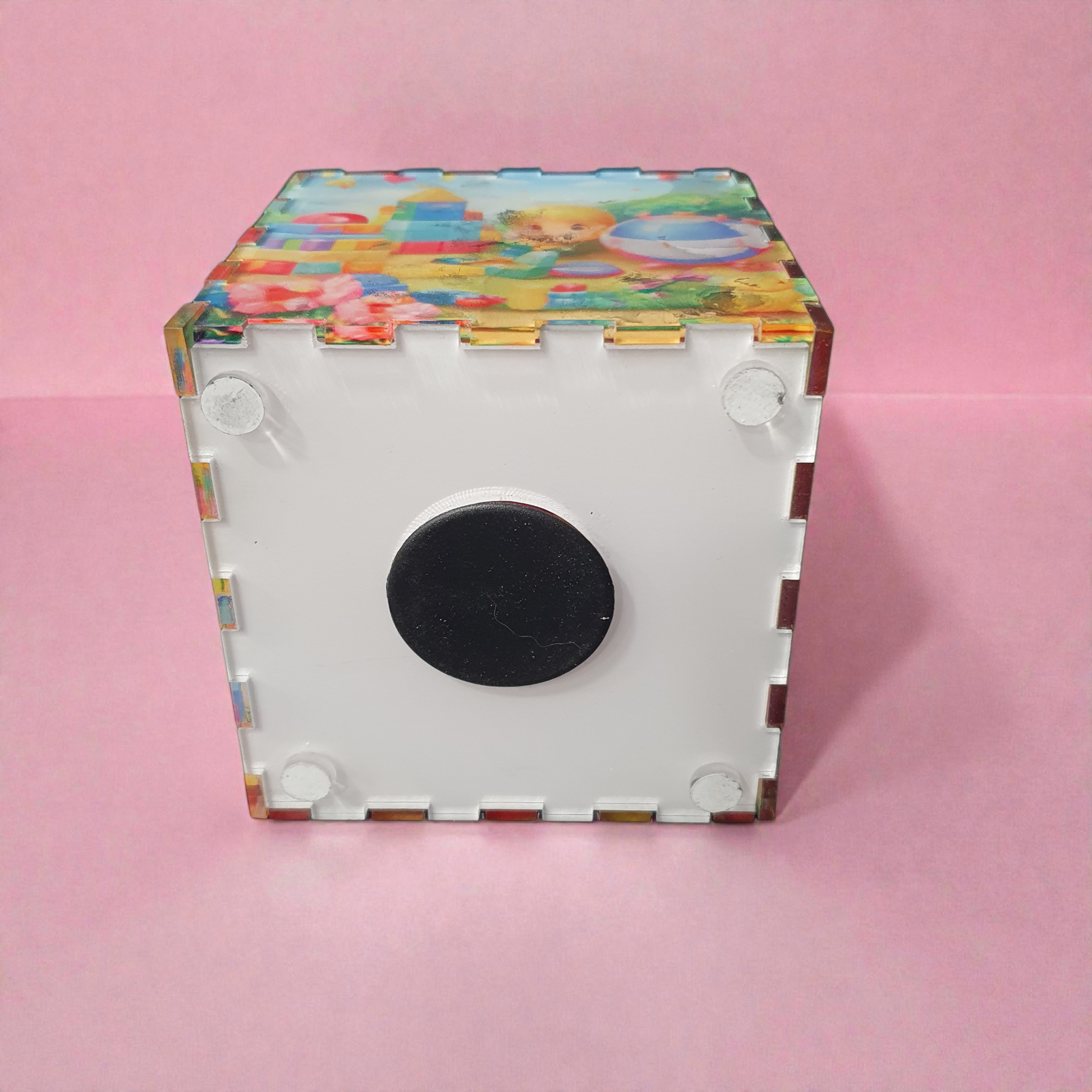 Bottom view of children’s piggy bank showing removable base with secure stopper for easy access to savings.