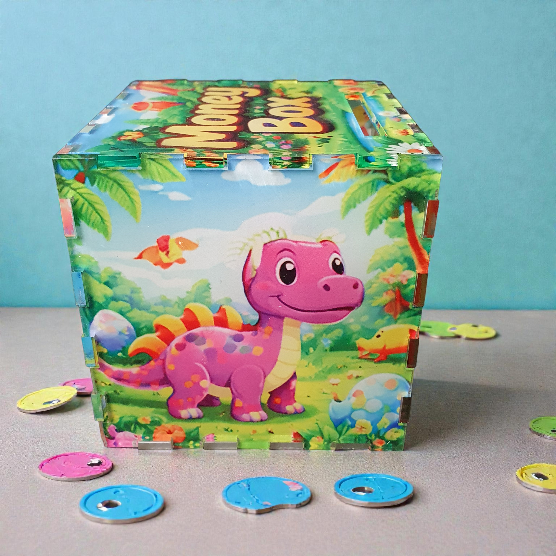Green cartoon dinosaur piggy bank with tropical landscape design, acrylic 10cm children’s money box.