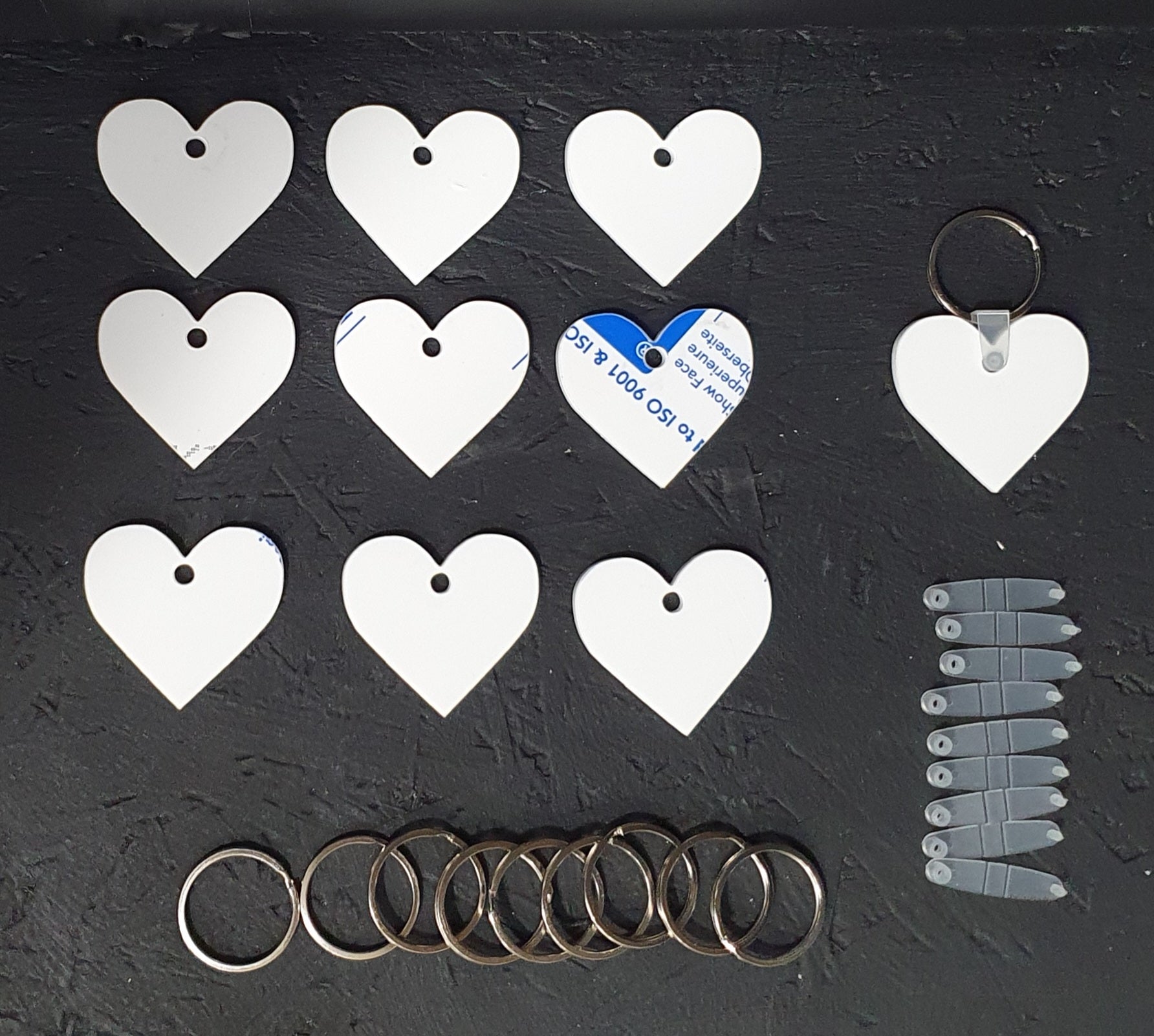 Heart shaped white cast acrylic keychain blank 50mm size with smooth curved edges and attached 30mm metal split ring for custom gifts.