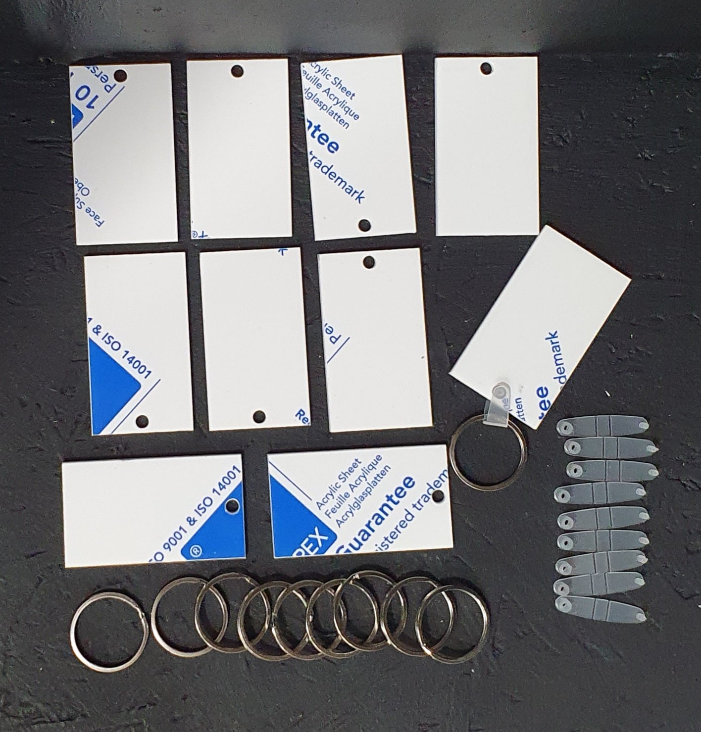 Rectangular white cast acrylic keychain blank with smooth surface and laser cut finish supplied with 30mm split ring.