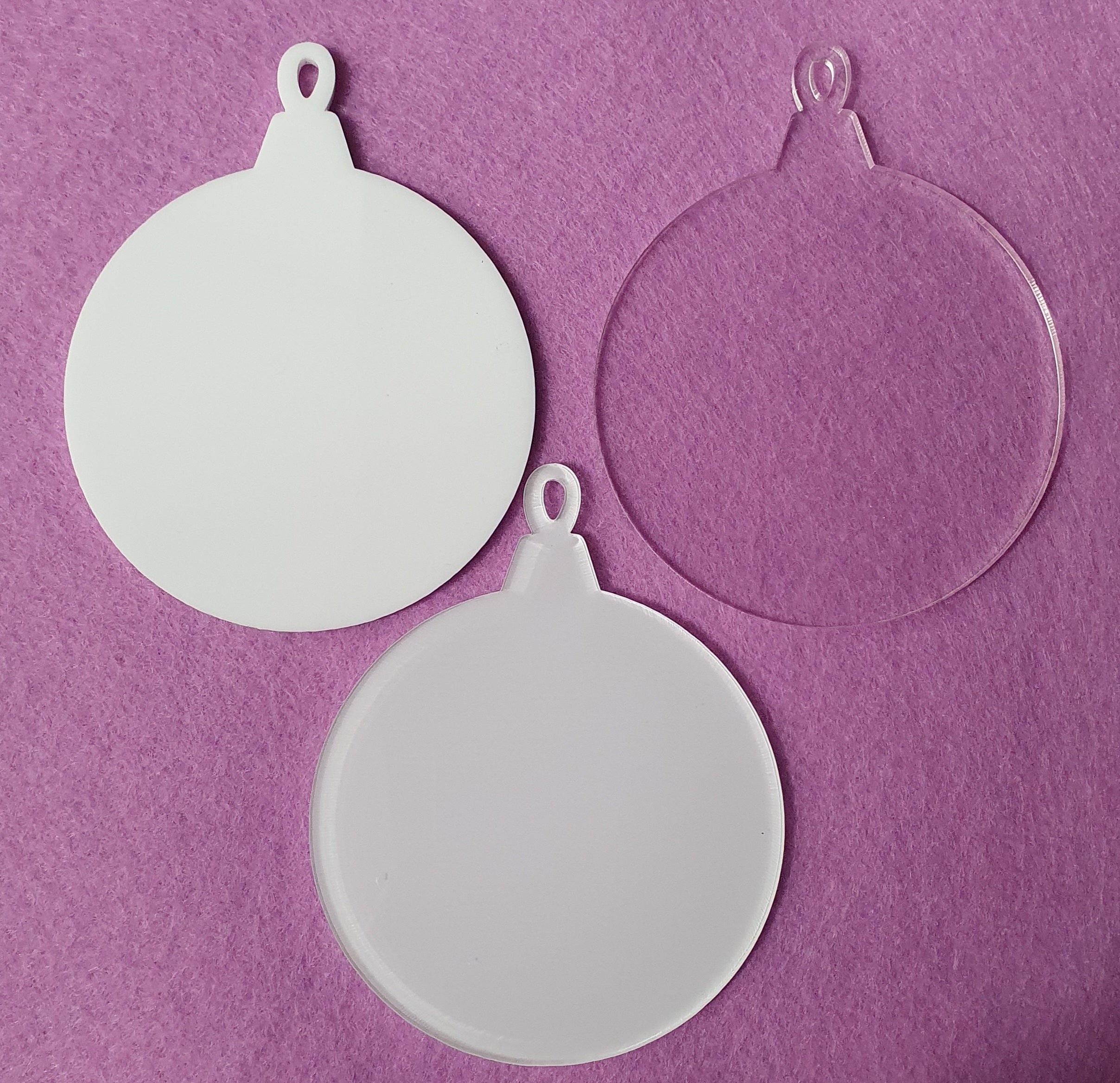 3mm cast acrylic bauble blanks measuring 7.5cm x 9.5cm in clear, white and sublimation reverse finishes with smooth laser cut edges.