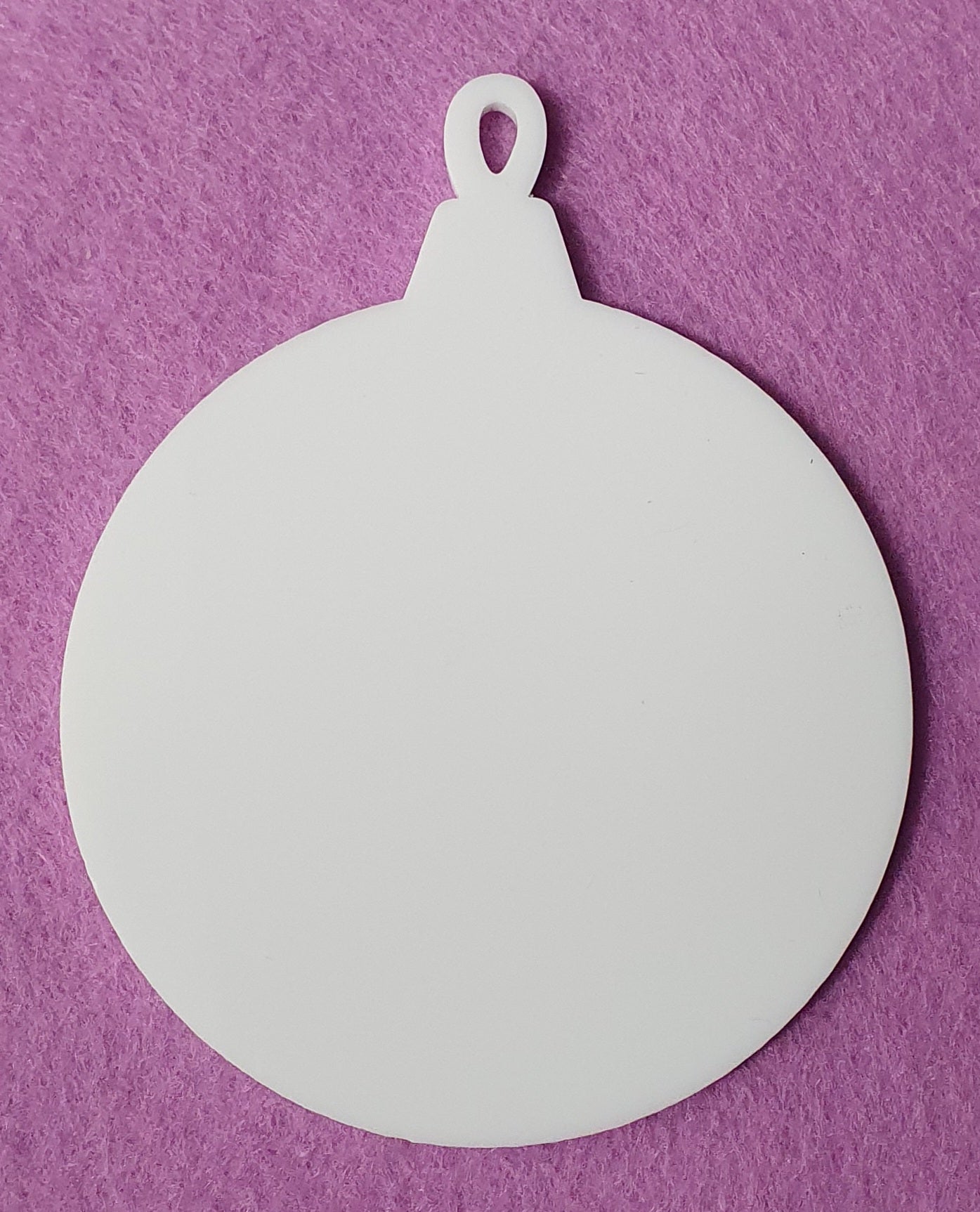 White acrylic hanging bauble blank close up showing solid surface ideal for vinyl, UV printing and sublimation projects.