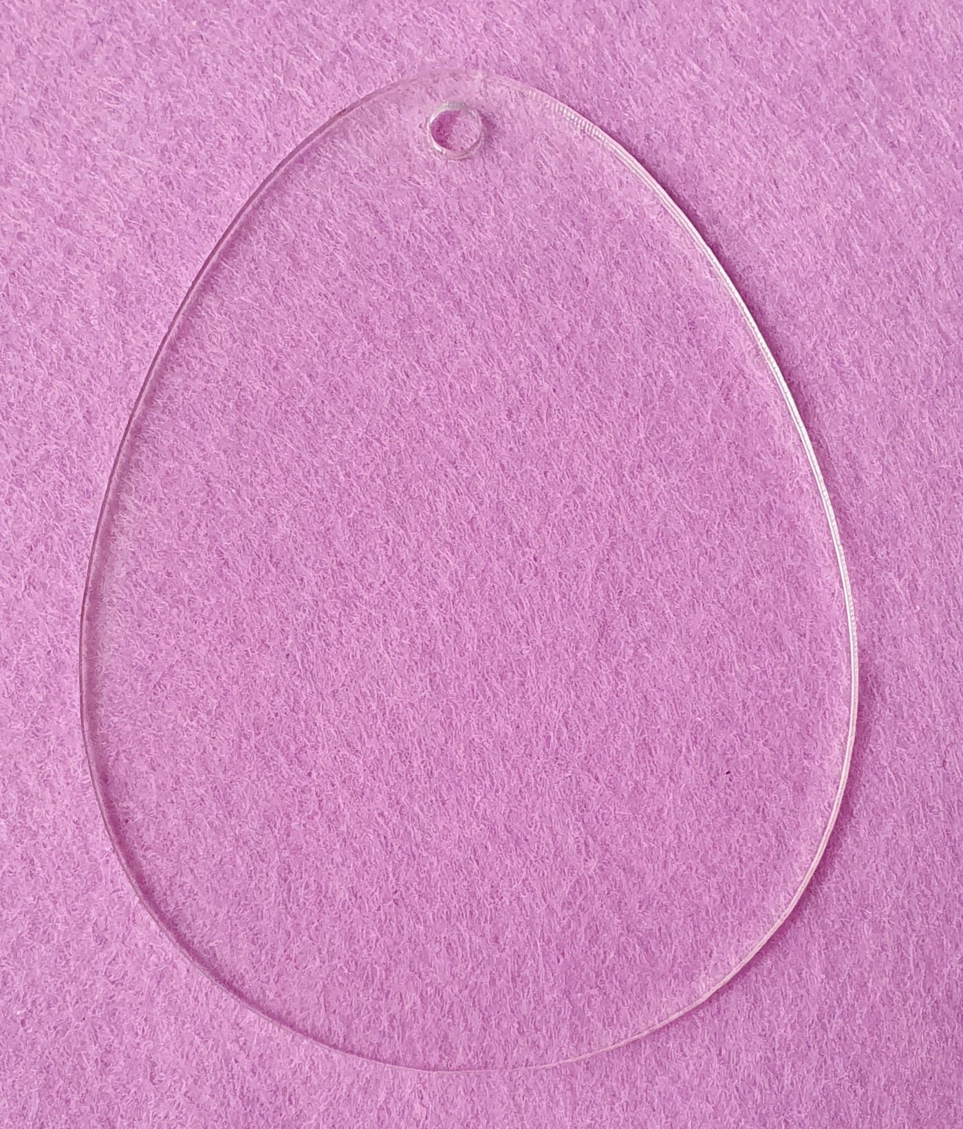 Clear acrylic Easter egg shape with optional hanging hole suitable for personalised seasonal decorations and keepsakes.