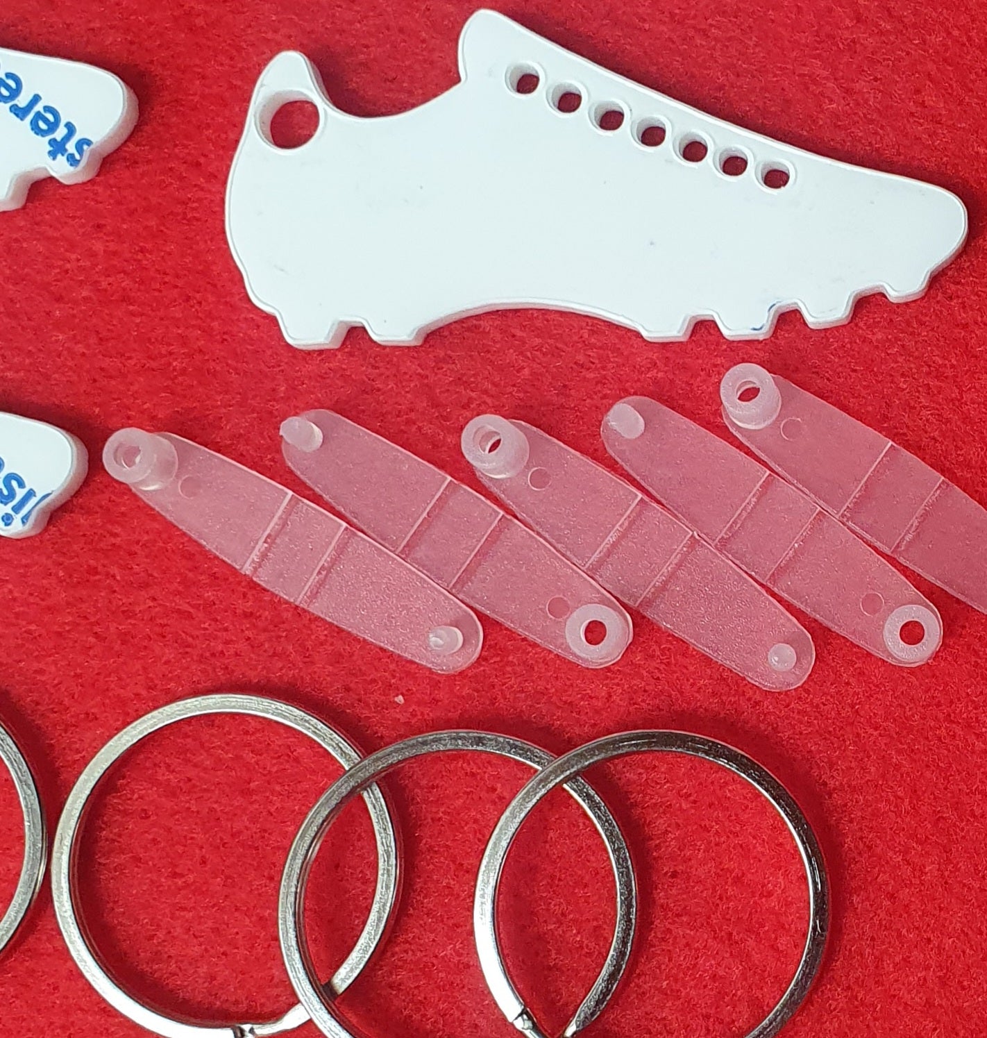 White acrylic football boot keyring blank close up showing solid surface suitable for sublimation, vinyl and UV printing.