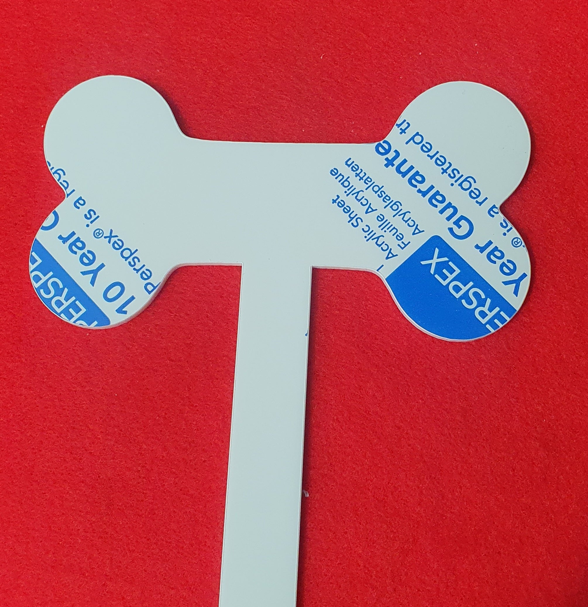 Clear acrylic dog bone grave marker blank designed for personalised pet remembrance tributes.