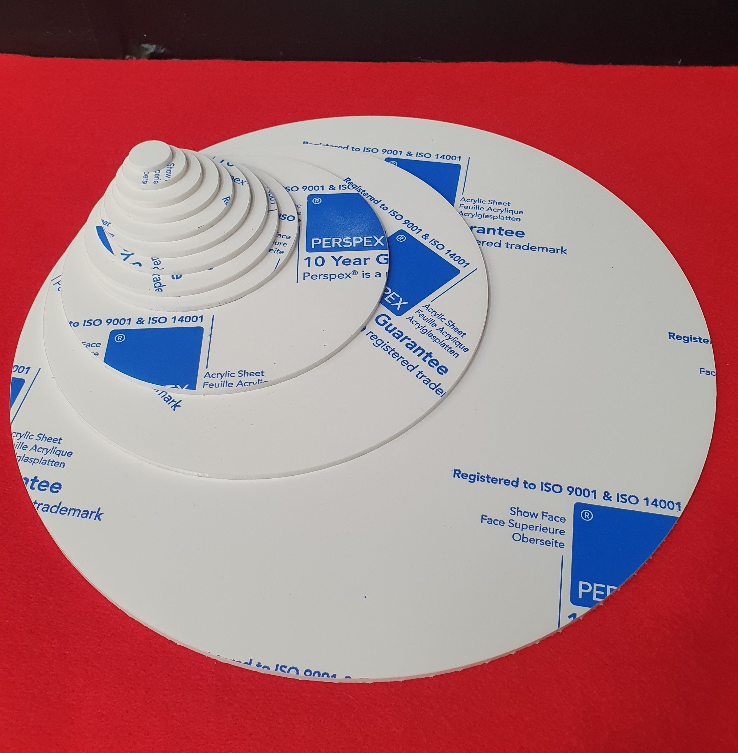 Assorted 3mm cast acrylic discs in various diameters from 20mm to 400mm displayed in white acrylic with smooth laser cut edges.
