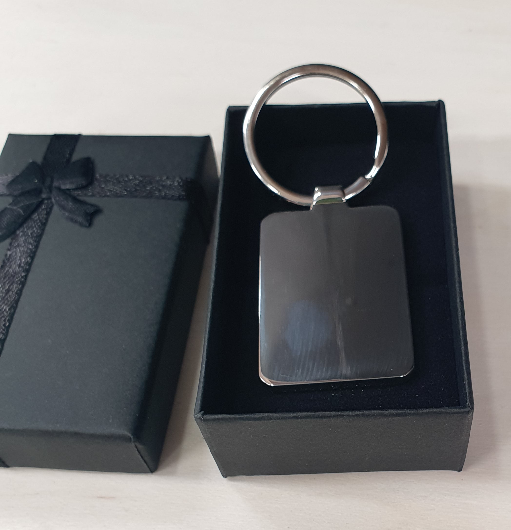 Personalised metal photo keyring with your own picture professionally printed in full colour. Suitable for photos of babies, pets, family or loved ones and supplied in a stylish black gift box, making a unique keepsake and personalised gift.