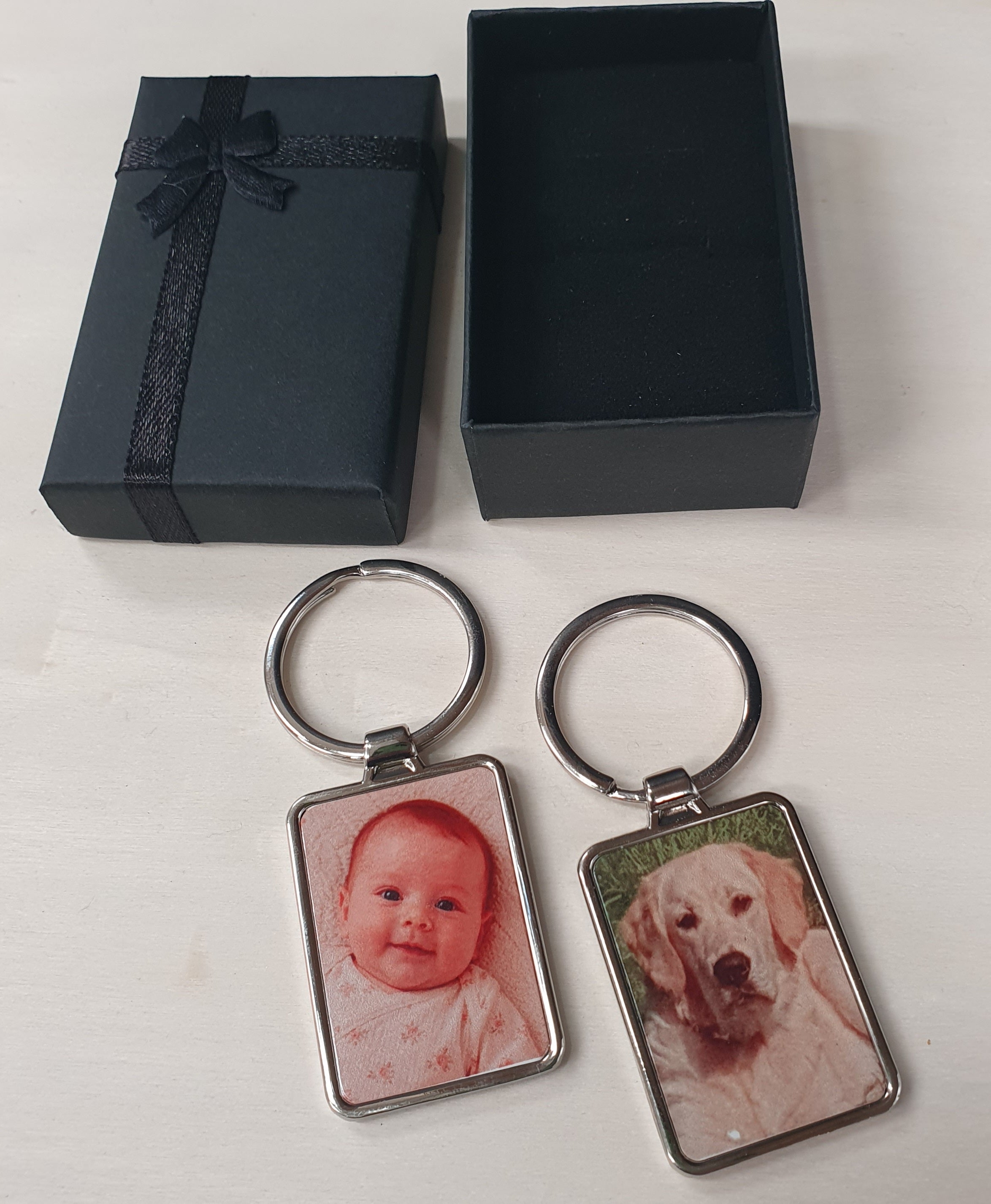 Personalised photo keyring with custom printed picture on a polished rectangular metal keychain. Presented in a black gift box with ribbon, perfect for adding a favourite family, baby, pet or memorial photo as a thoughtful keepsake gift.