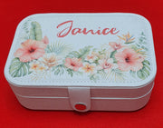 Personalised white travel jewellery box with the name Janice printed on the lid, decorated with tropical hibiscus flowers and botanical leaves, ideal for storing rings, earrings and necklaces.