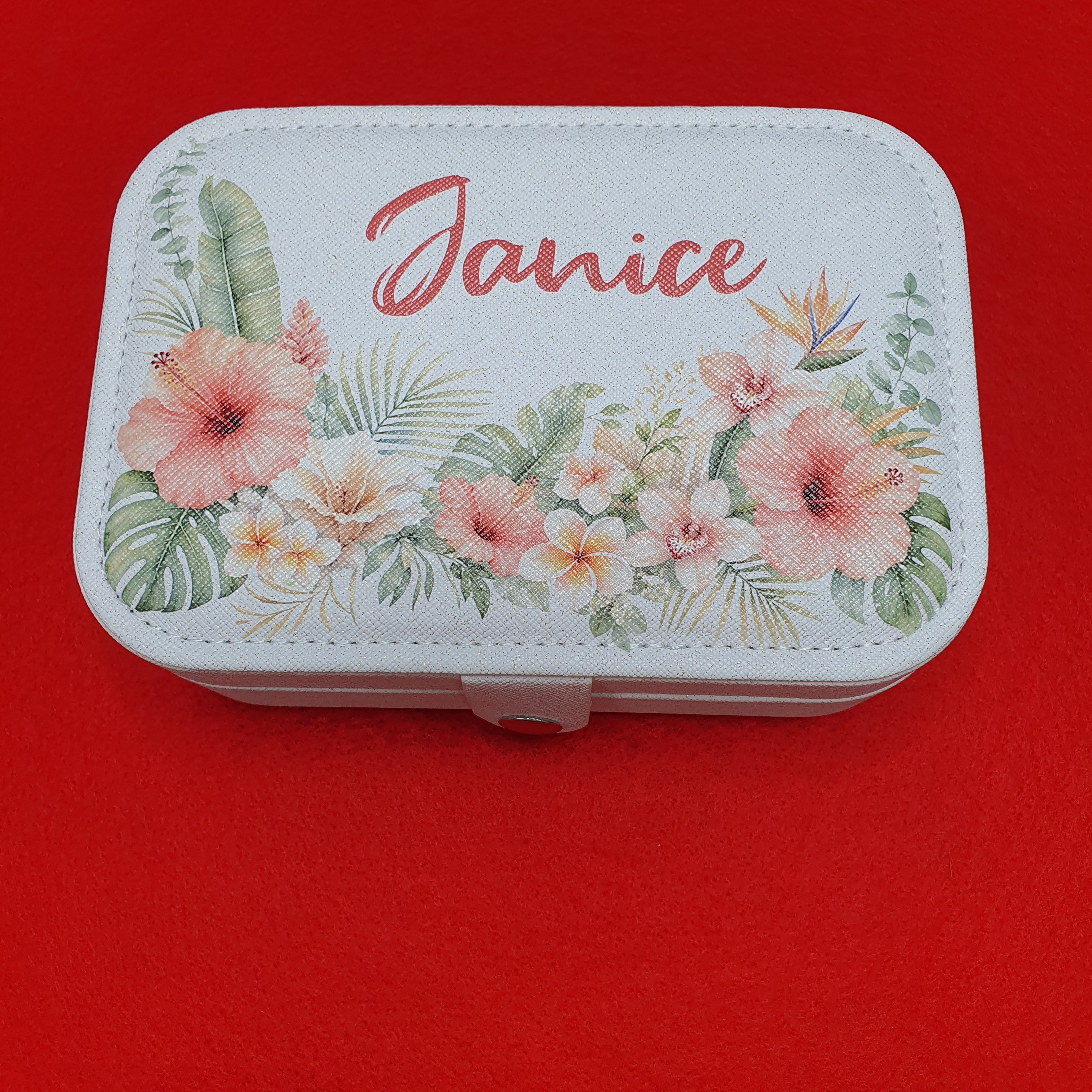 Personalised travel jewellery case with ring rolls, necklace hooks, earring organiser and storage compartments, finished with a beautiful custom floral lid design.