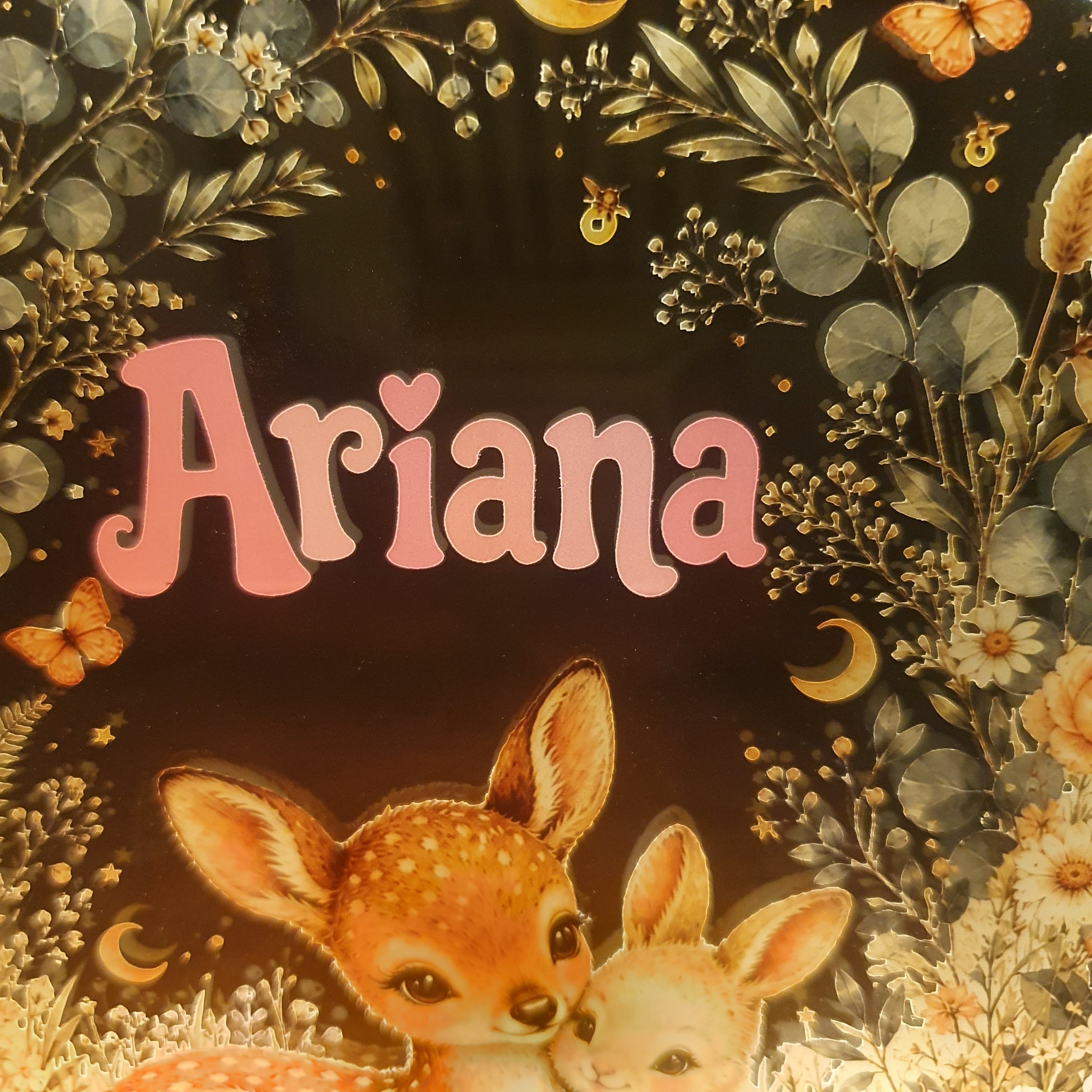 Personalised children's bedroom lamp with a woodland animal design, featuring a deer and rabbit beneath a moonlit sky, illuminated by a warm LED wooden base.