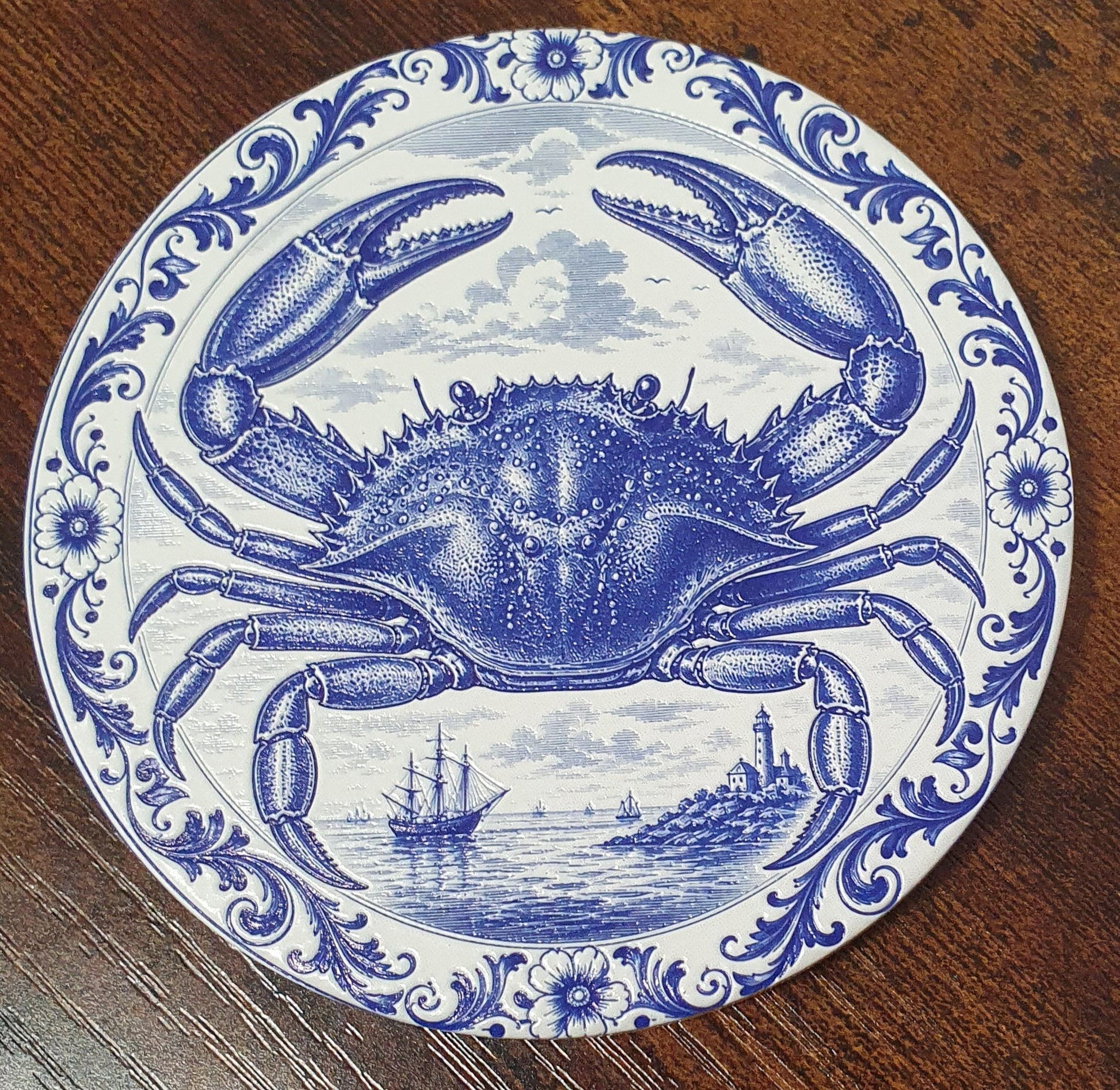 Set of six ceramic sea creature coasters featuring cobalt blue illustrations of ocean animals with cork backing.