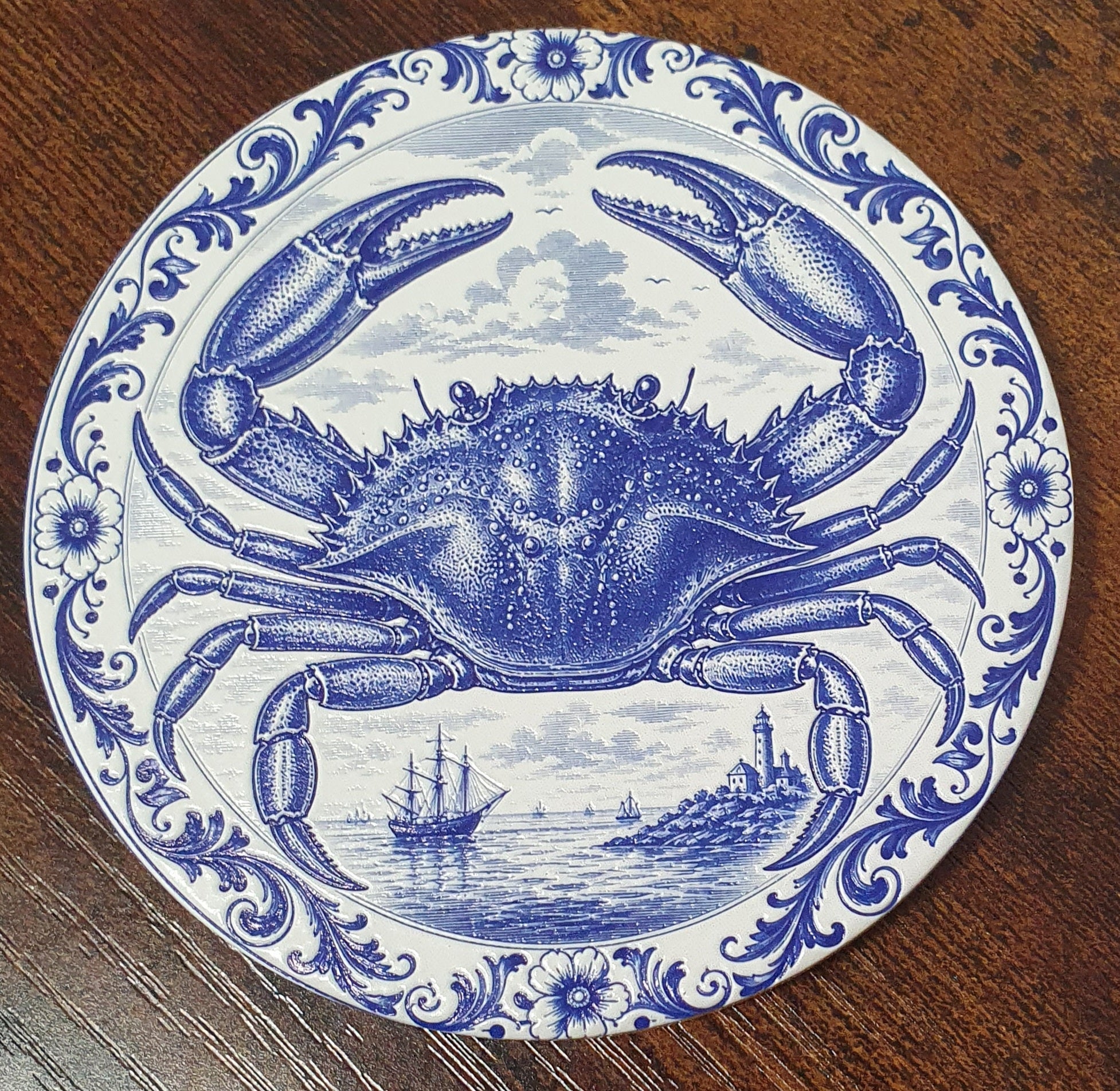 Set of six ceramic sea creature coasters featuring cobalt blue illustrations of ocean animals with cork backing.
