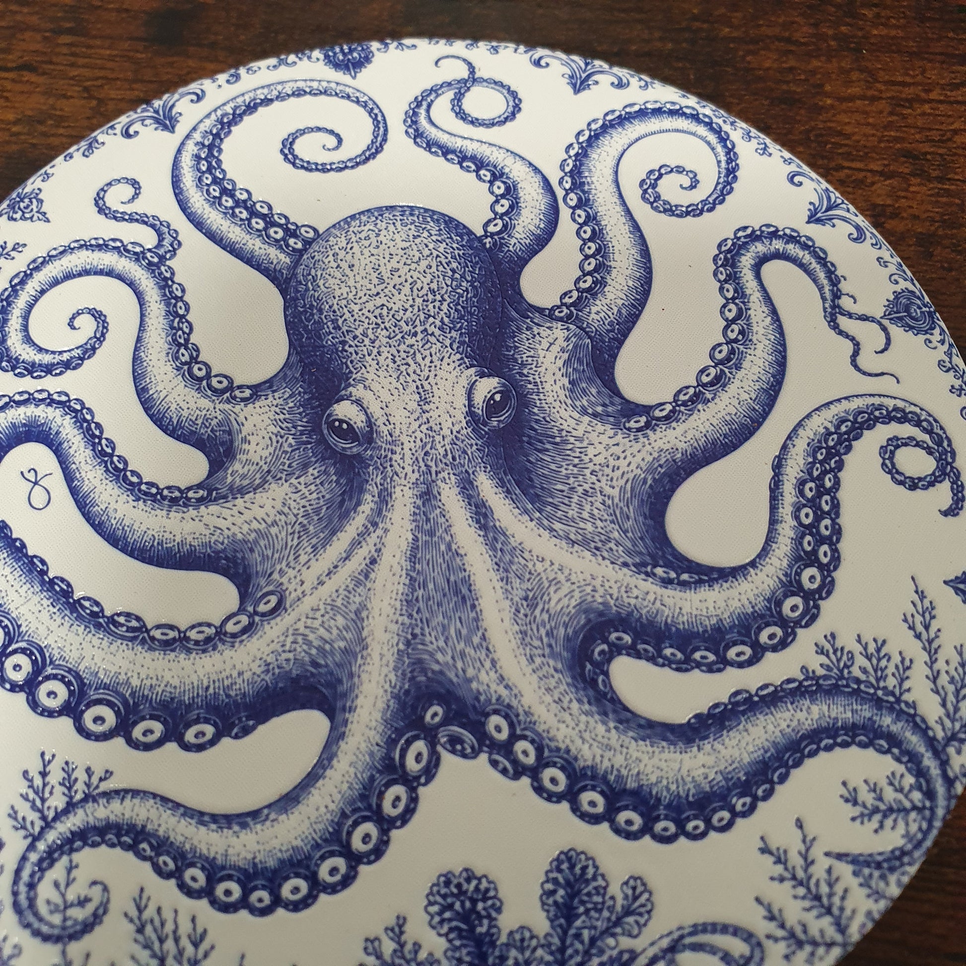 Set of six ceramic sea creature coasters featuring cobalt blue illustrations of ocean animals with cork backing.