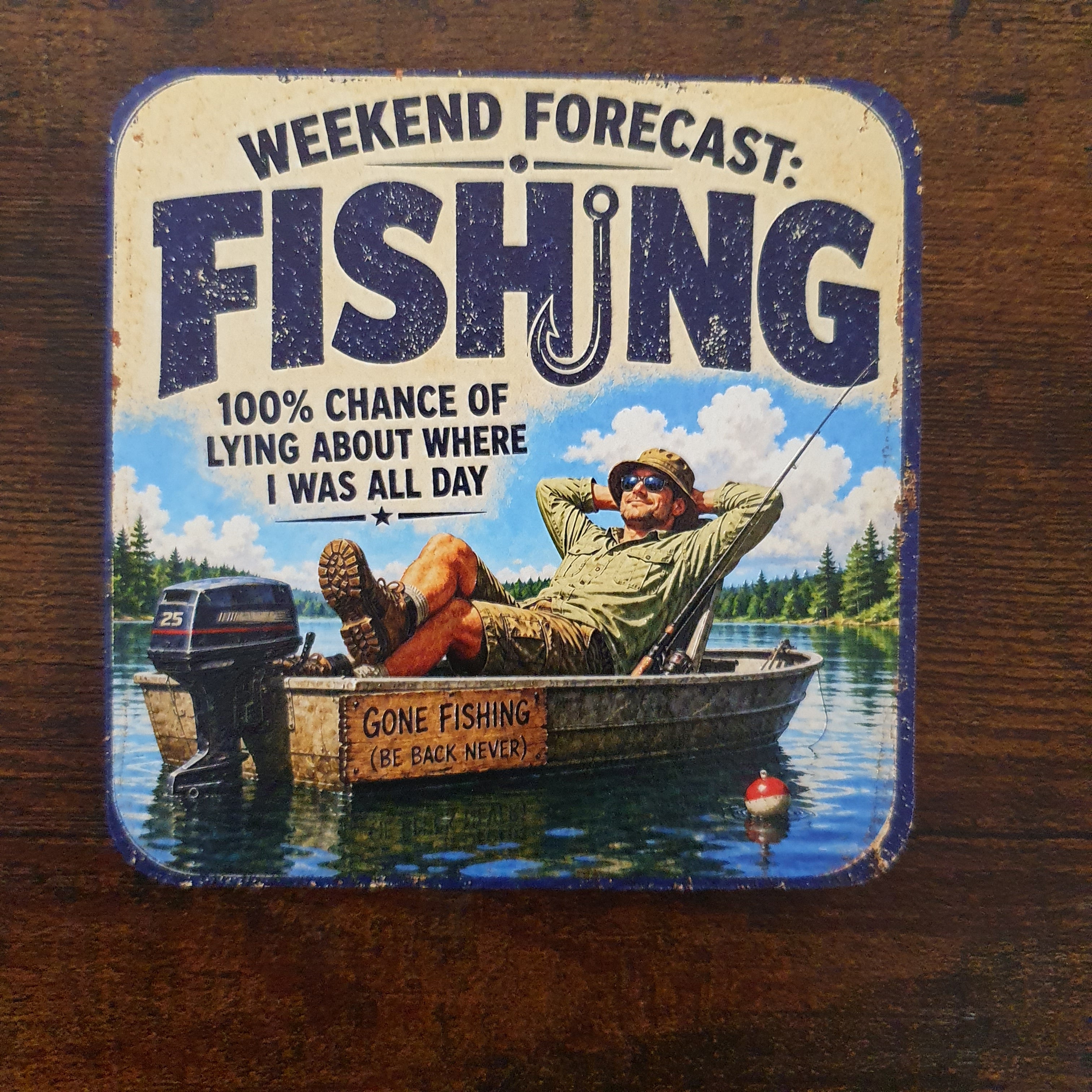 Rustic wooden fishing coaster featuring the quote "Weekend Forecast: Fishing" with an angler relaxing in a boat on a peaceful lake, printed with a textured UV finish.