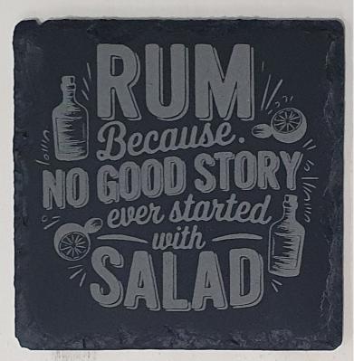 Slate coaster with engraved text and bottle illustrations on a dark background