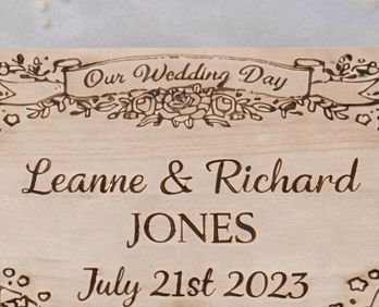 Engraved wooden keepsake box with hinged lid and metal clasp