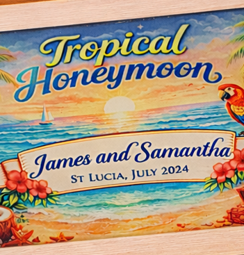 Close-up of personalised honeymoon keepsake box lid showing tropical illustration with names, location and date