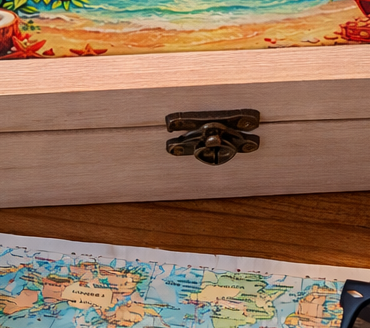 Personalised honeymoon memory box displayed with travel maps, seashells, flowers and holiday souvenirs on a wooden table