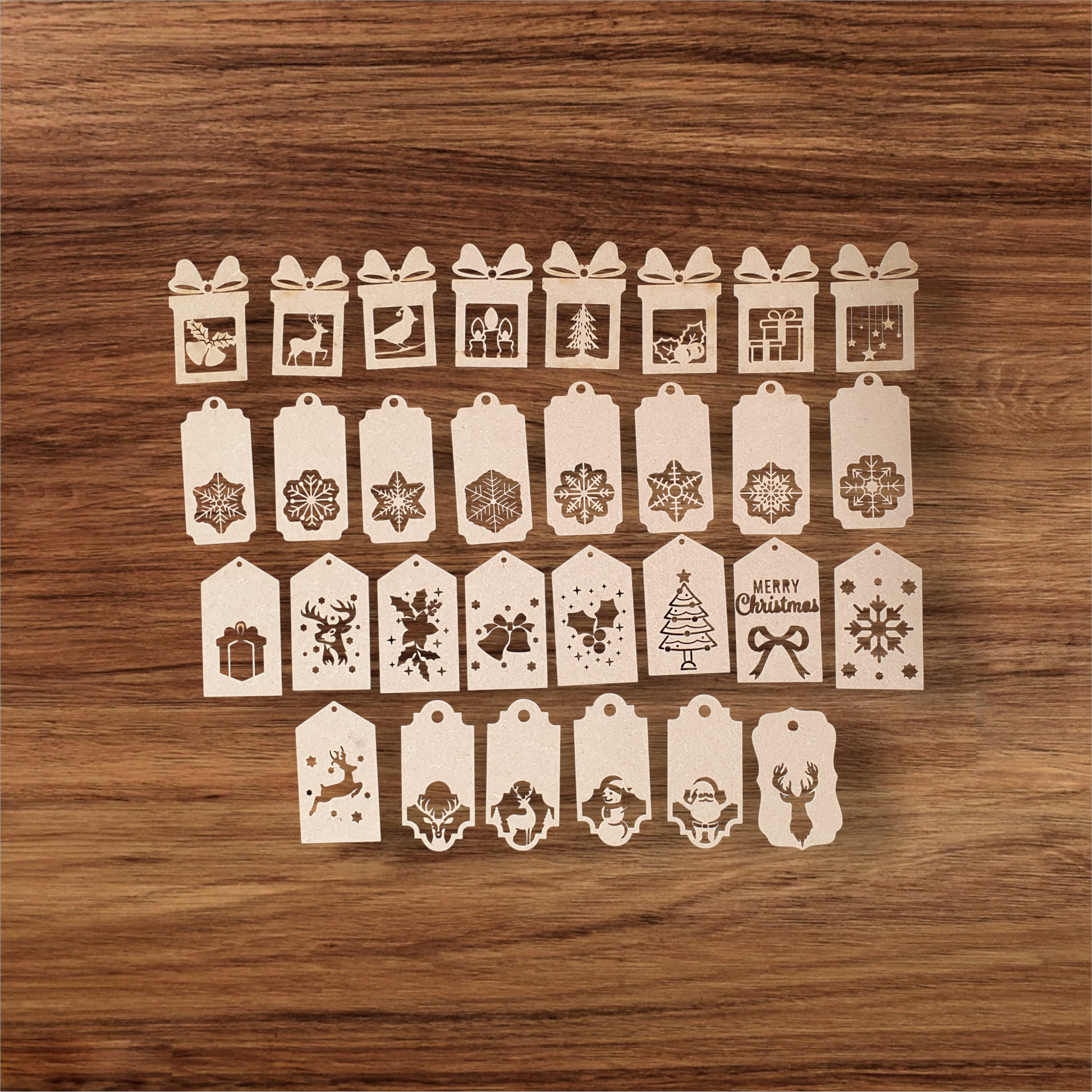 Laser-cut MDF Christmas gift tags with festive designs including Santa and snowflakes