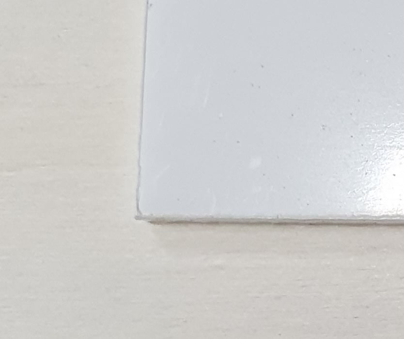 Detailed view of acrylic bookmark blank edge showing smooth laser-cut acrylic finish and glossy surface.