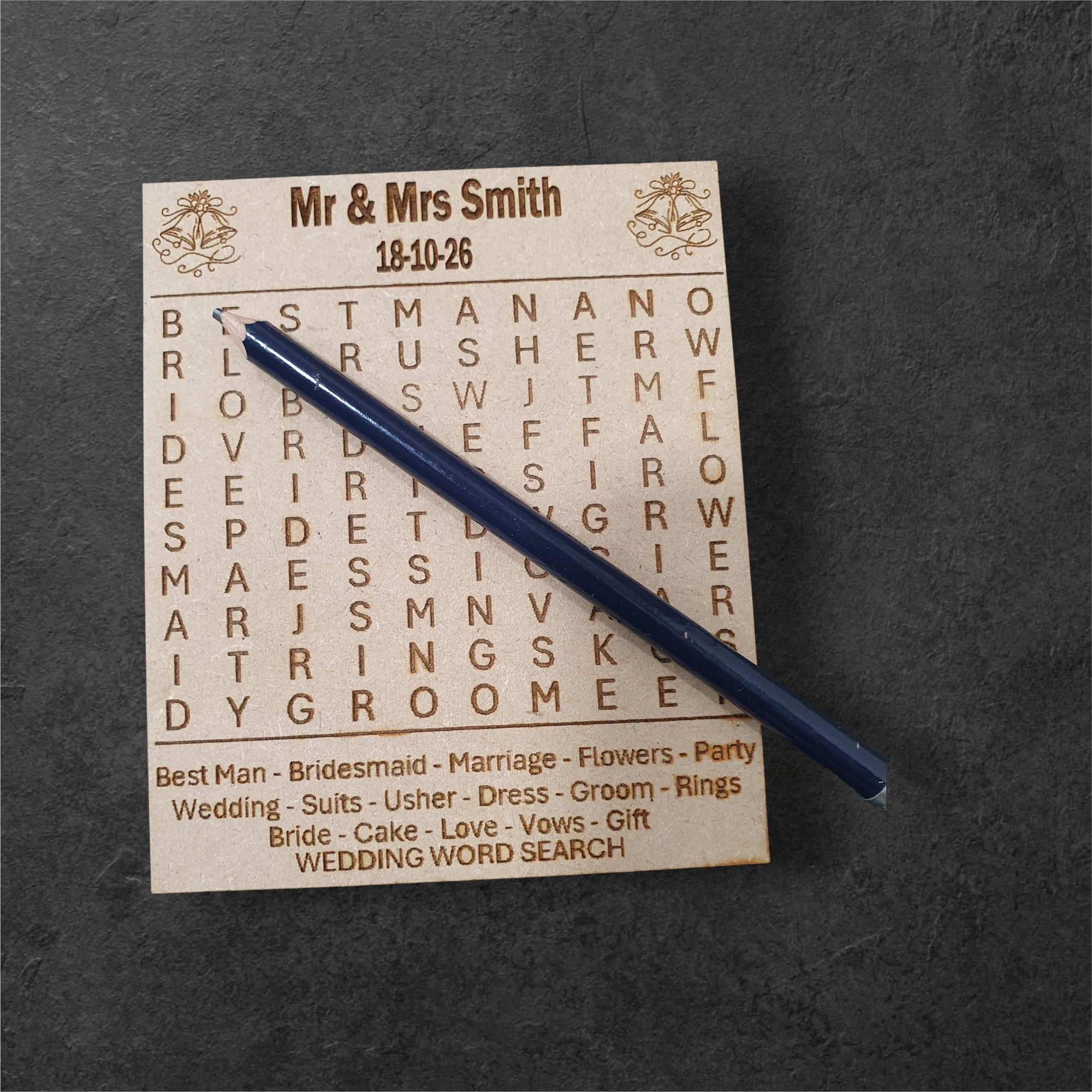 Engraved wooden wedding keepsake games displayed on a rustic table
