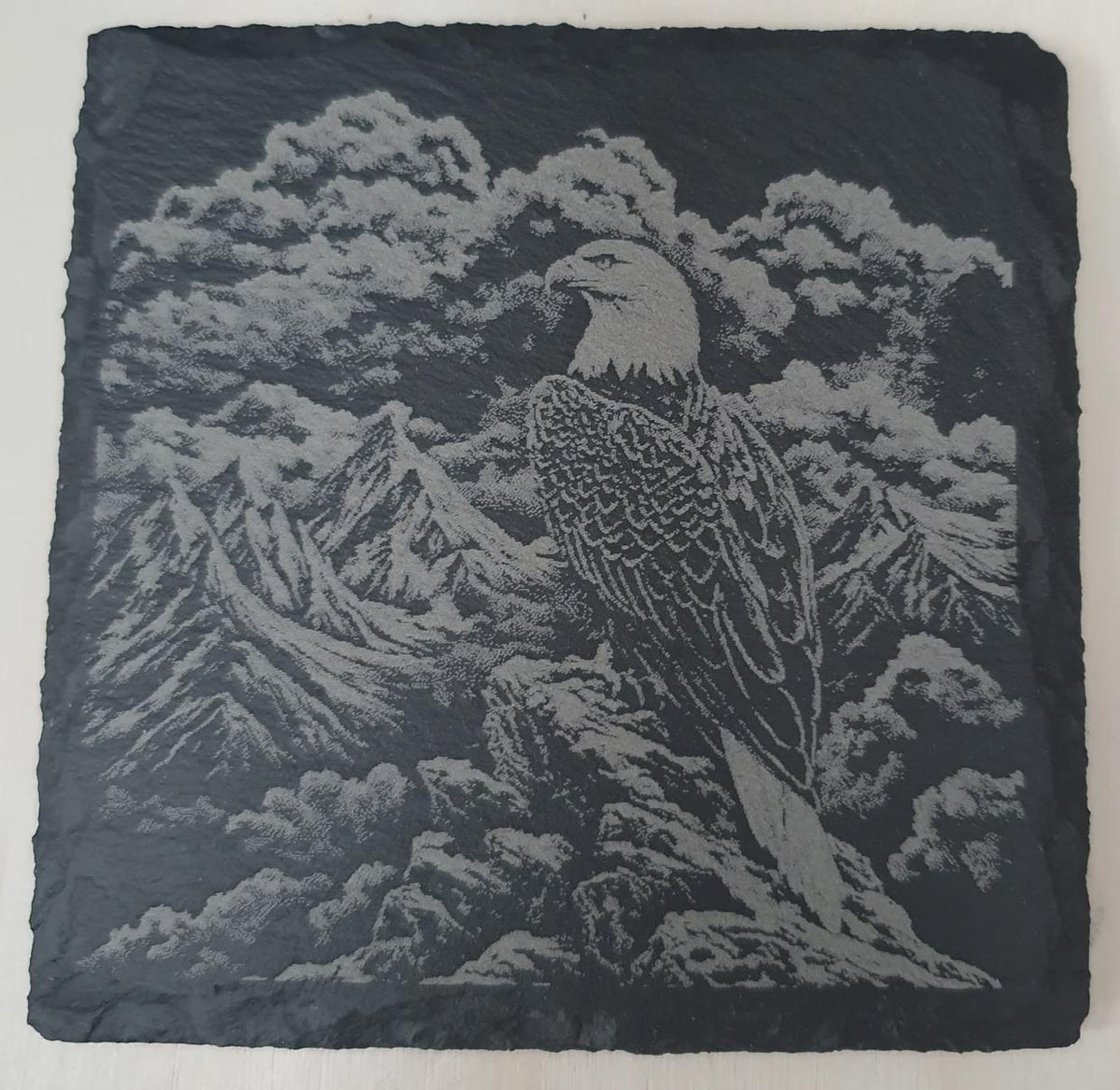Close up of laser-engraved slate tiles with detailed birds of prey artwork including eagle, owl, falcon and kestrel. Handcrafted wildlife slate décor with precision etching, perfect for nature lovers and bird enthusiast gifts.