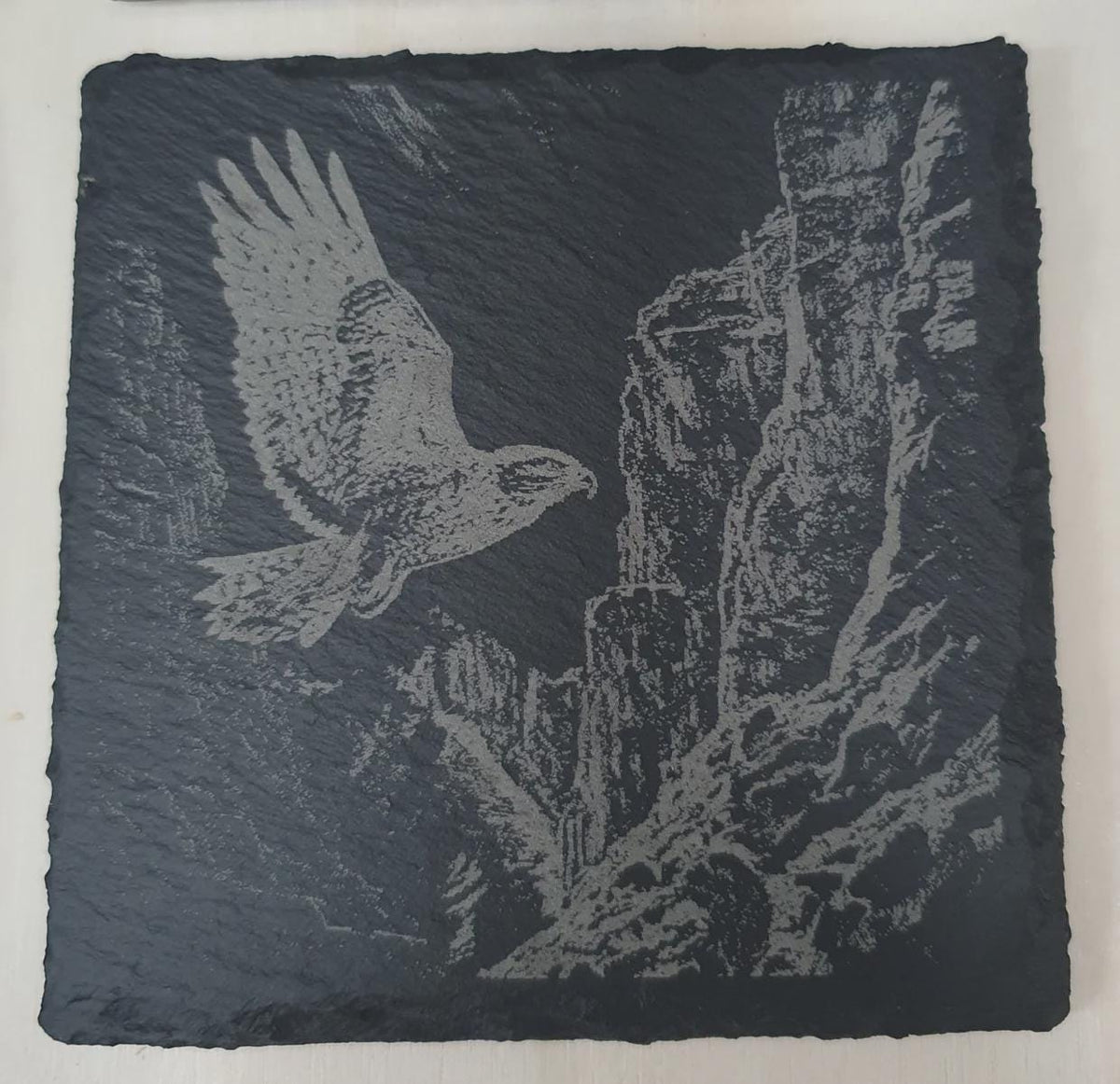 Birds of prey slate tile set displayed in home décor setting, engraved eagle, owl, falcon and kestrel on natural slate. Rustic nature art tiles, perfect decorative wildlife décor for living room, study or office.