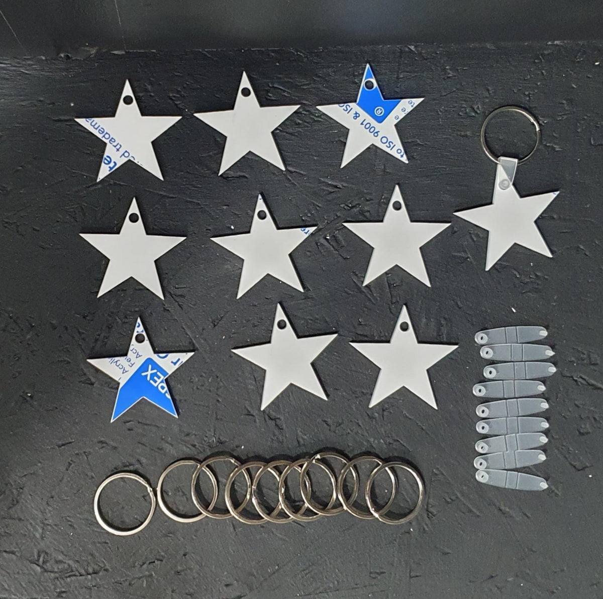 White cast acrylic star keyring blank approximately 50mm with clear tag fitting and 30mm metal split ring, ideal for vinyl and engraving projects.