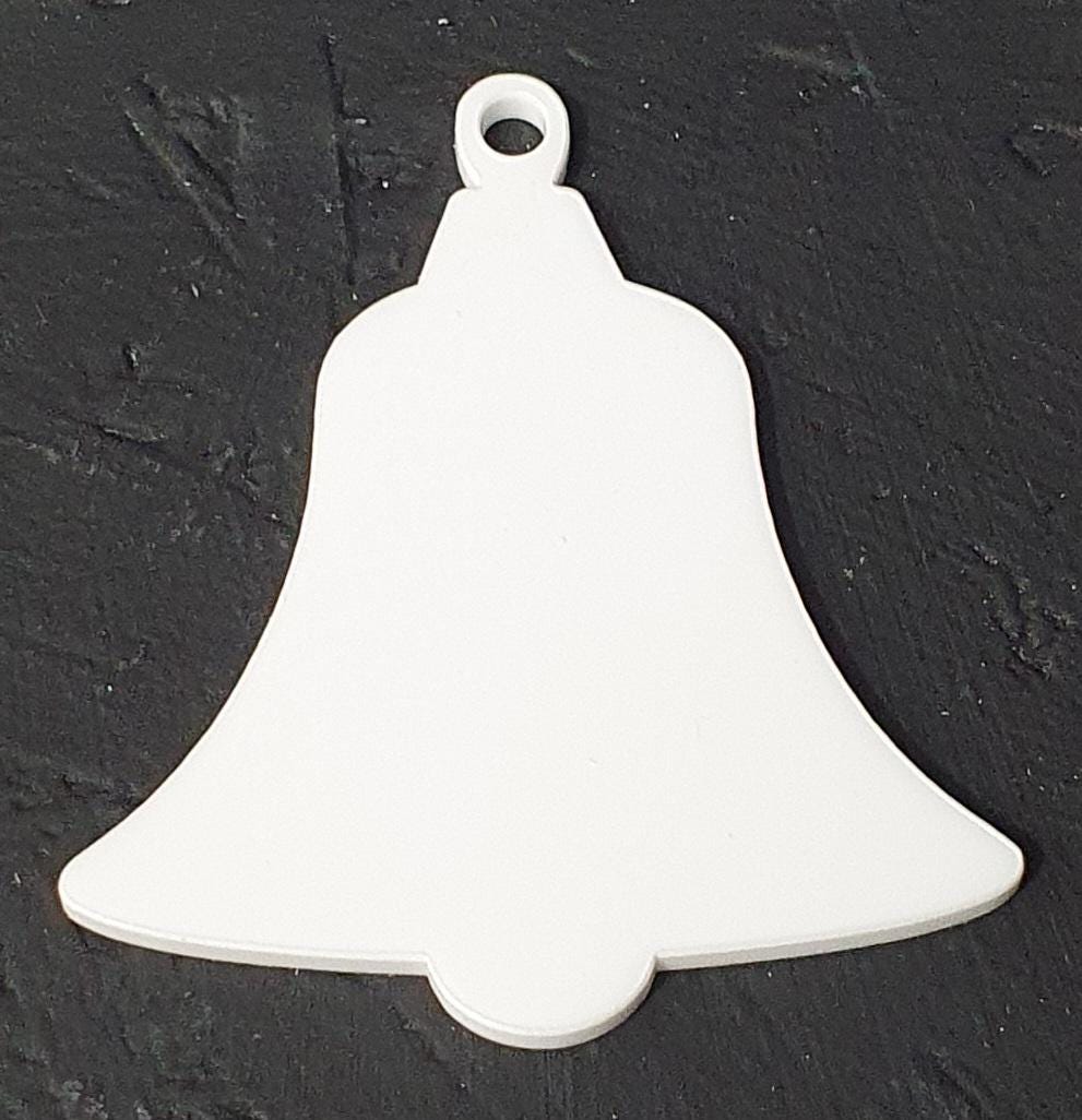 White cast acrylic bell blank in larger size showing solid smooth surface ideal for vibrant sublimation printing, vinyl application and Christmas decoration crafting.