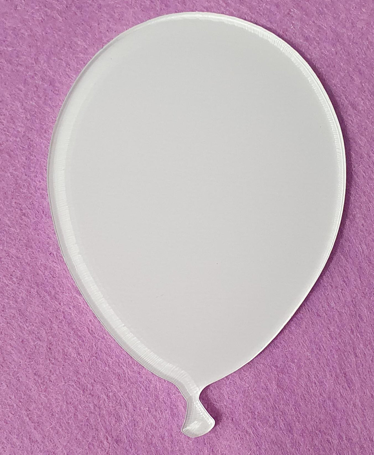 White acrylic balloon blank with visible layered edge detail demonstrating durable 3mm cast acrylic thickness for long lasting craft projects.
