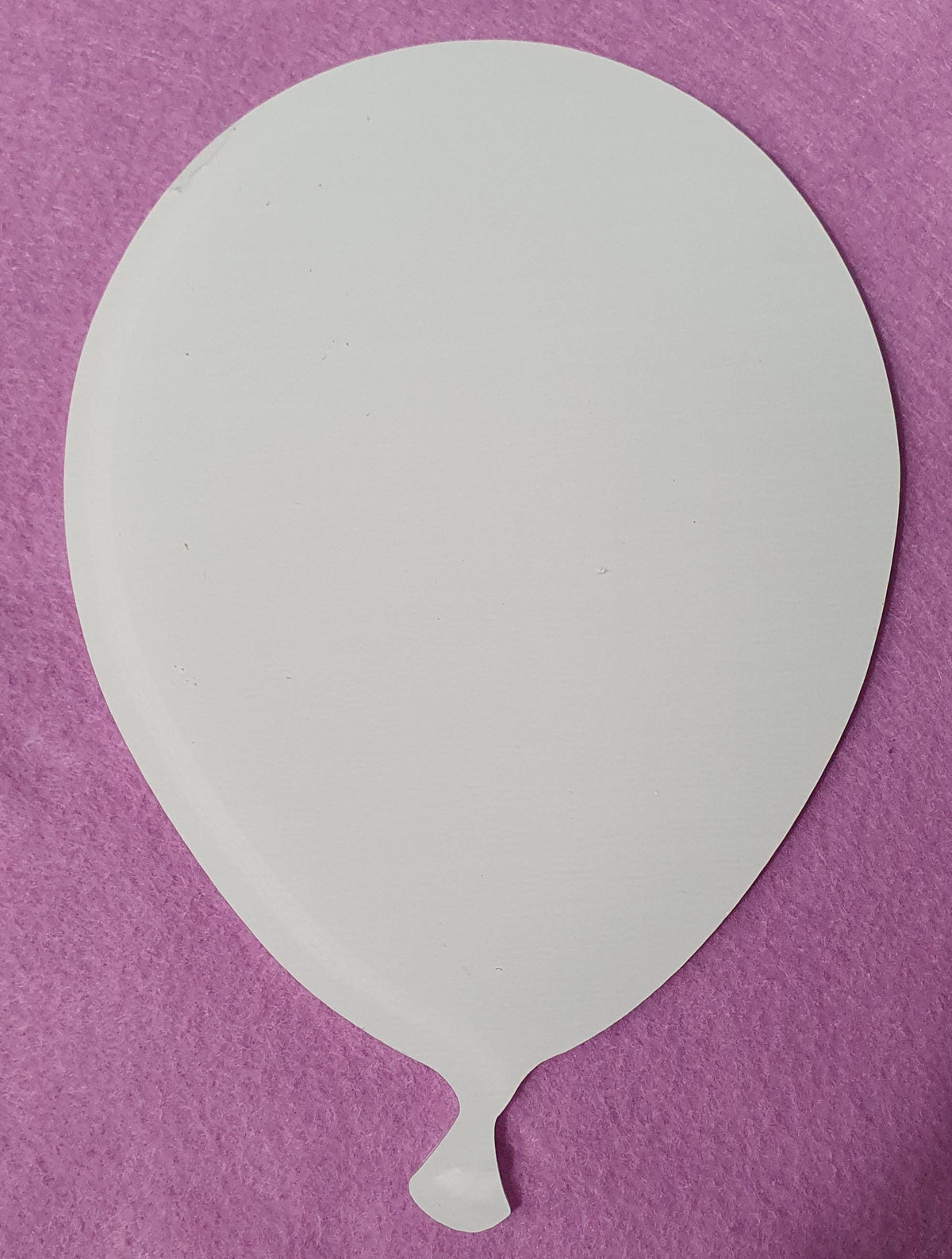 White cast acrylic balloon blank close up showing smooth surface and precision laser cut edges suitable for vinyl, sublimation and UV printing.