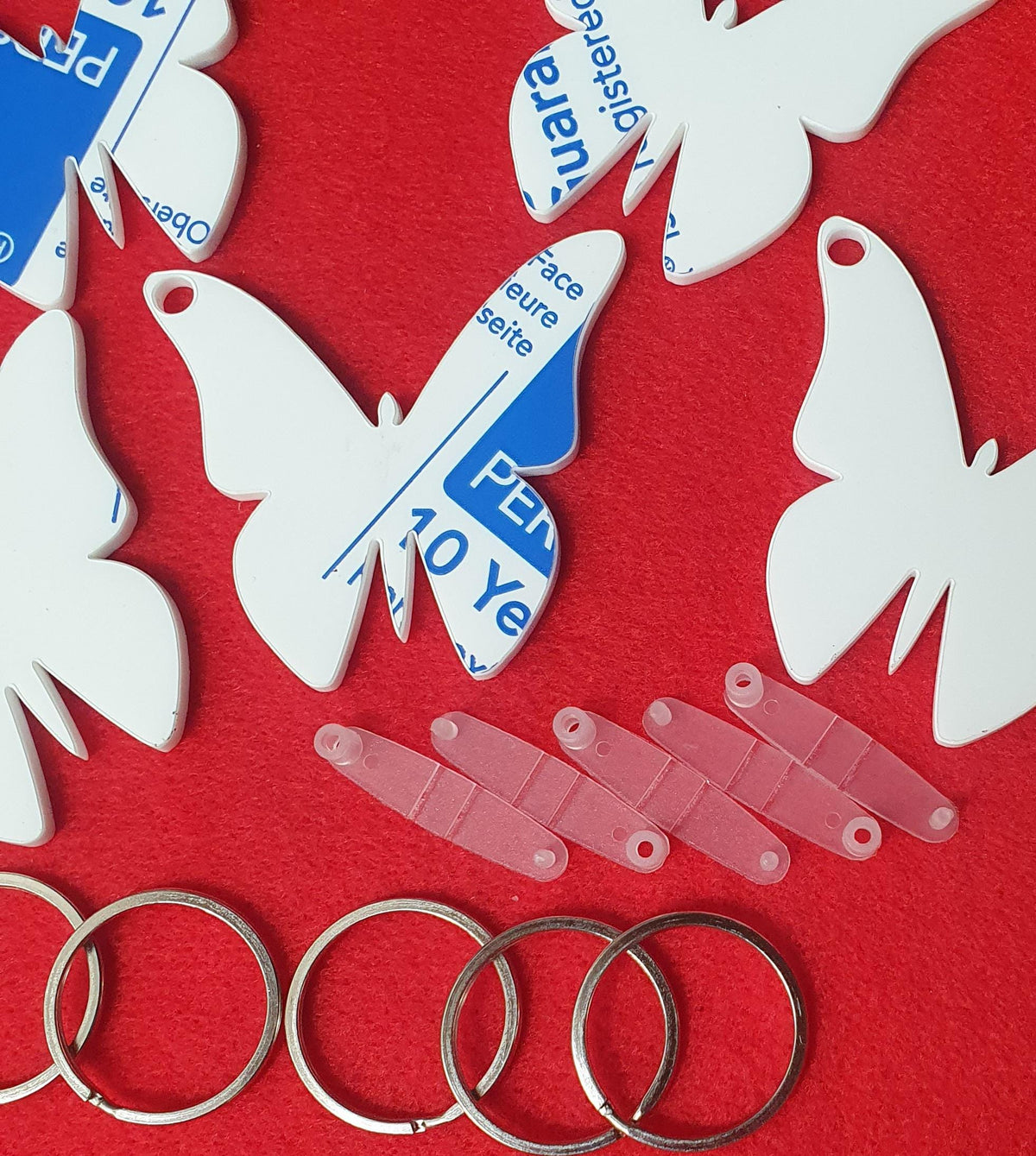 Clear acrylic butterfly keyring blanks supplied with snap clips and split rings ready for personalised gifts and event favours.