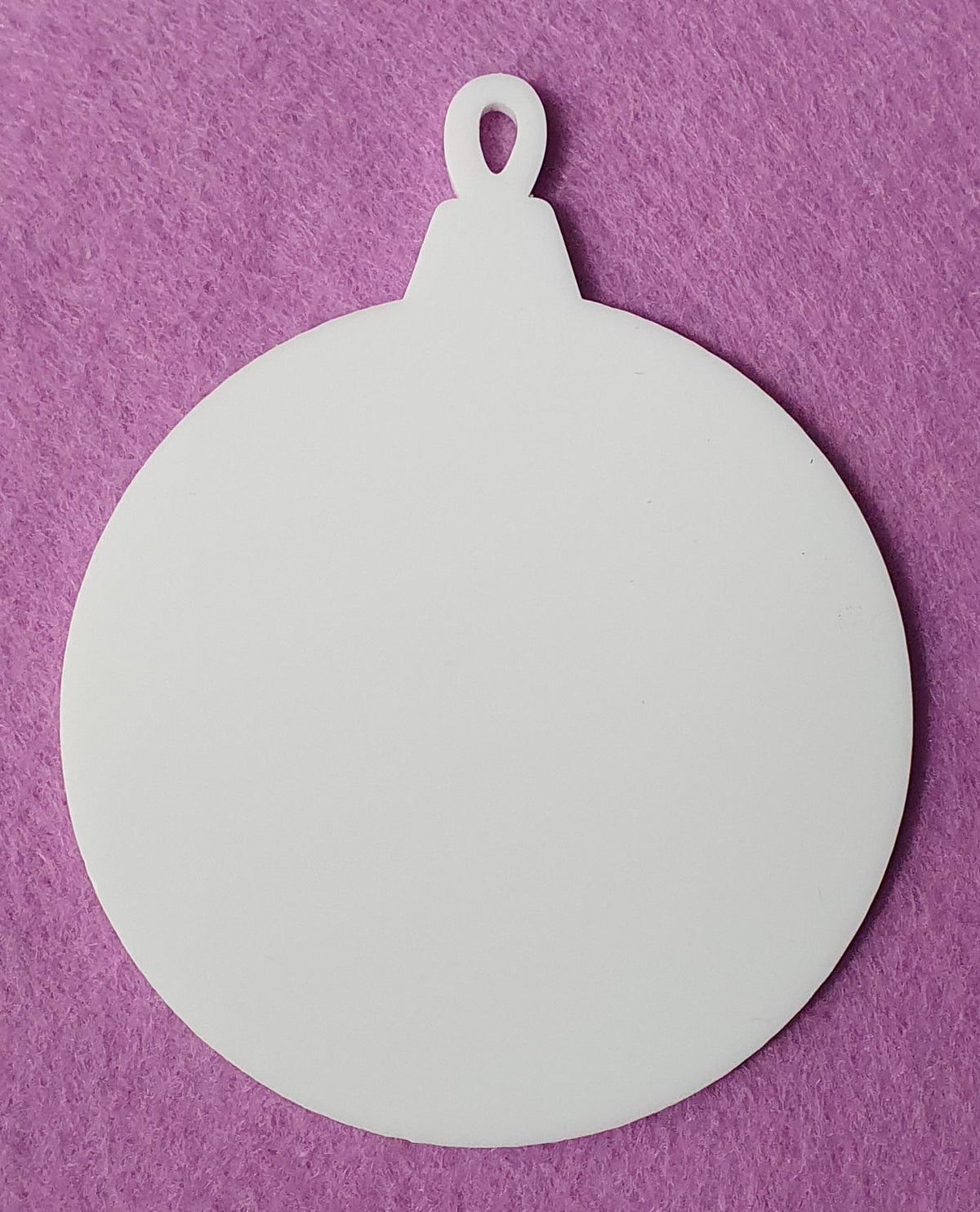 White cast acrylic bauble blank close up showing smooth surface and clean laser cut edges, ideal for vinyl, sublimation and UV printing projects.