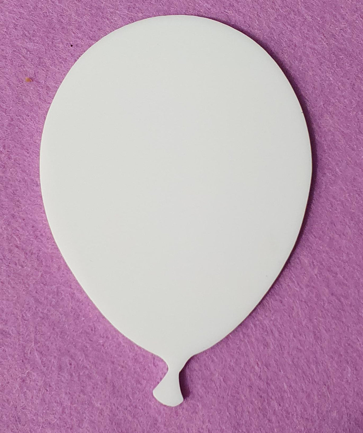 White cast acrylic balloon blank close up showing smooth surface and precision laser cut edges suitable for vinyl, sublimation and UV printing.