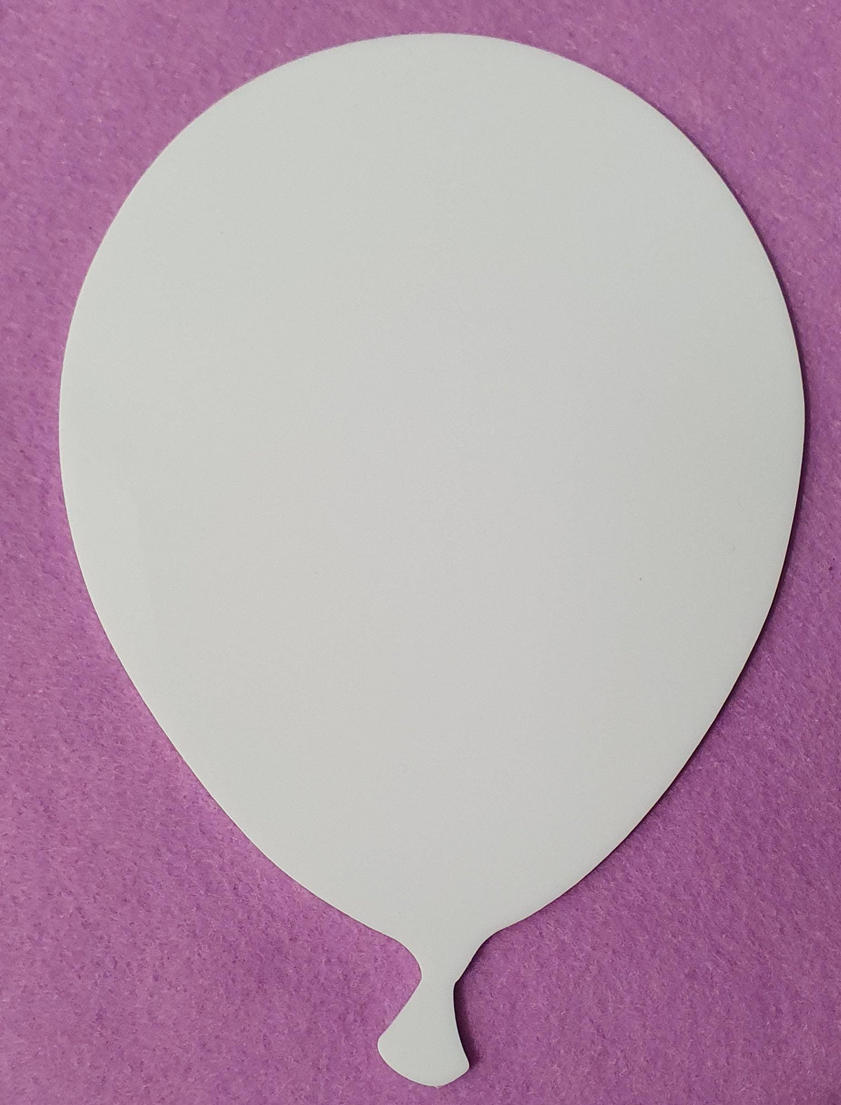 White acrylic balloon blank with visible layered edge detail demonstrating durable 3mm cast acrylic thickness for long lasting craft projects.