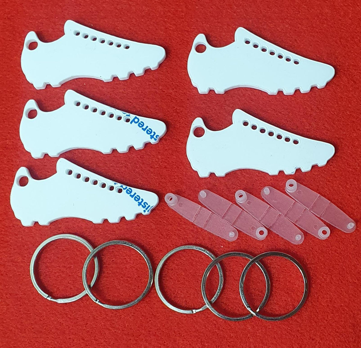 3mm cast acrylic football boot keyring blanks measuring 6.3cm x 3cm with detailed stud design and hanging hole.