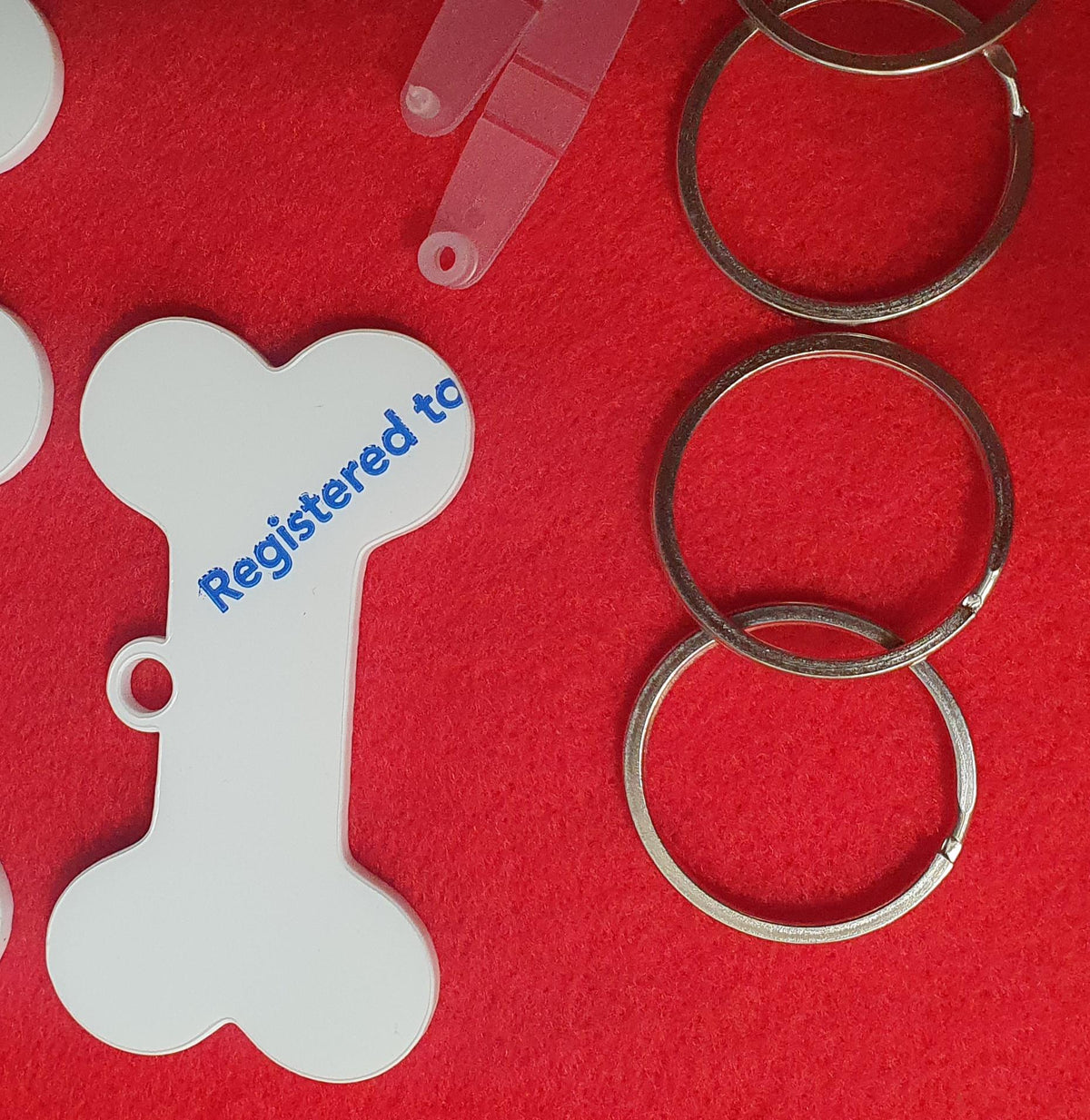 Dog bone acrylic keyring blanks supplied with snap clips and split rings ideal for personalised pet tags and gifts.
