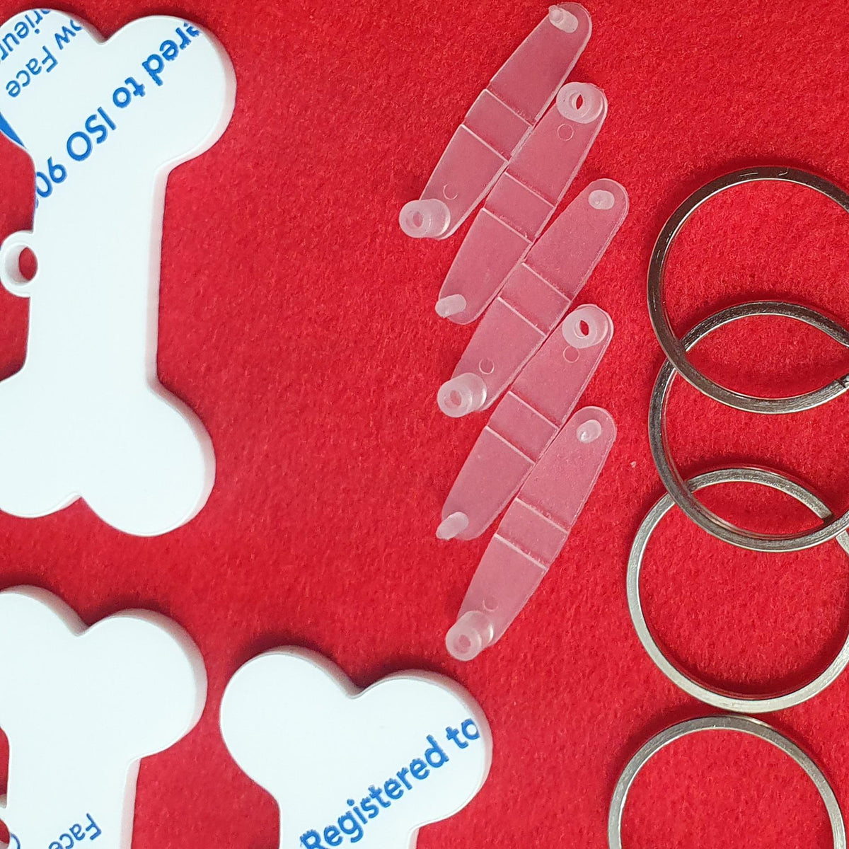 White acrylic dog bone shape close up showing solid surface suitable for sublimation, vinyl and UV printing.