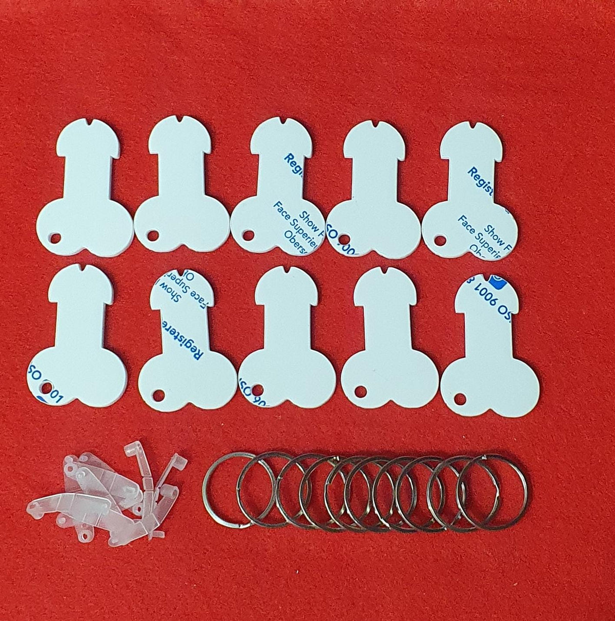 White acrylic willy shaped trolley token blanks with keyring clips and split rings